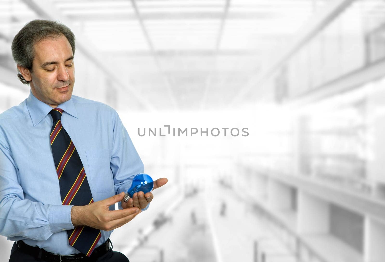 mature business man with a lamp at the office