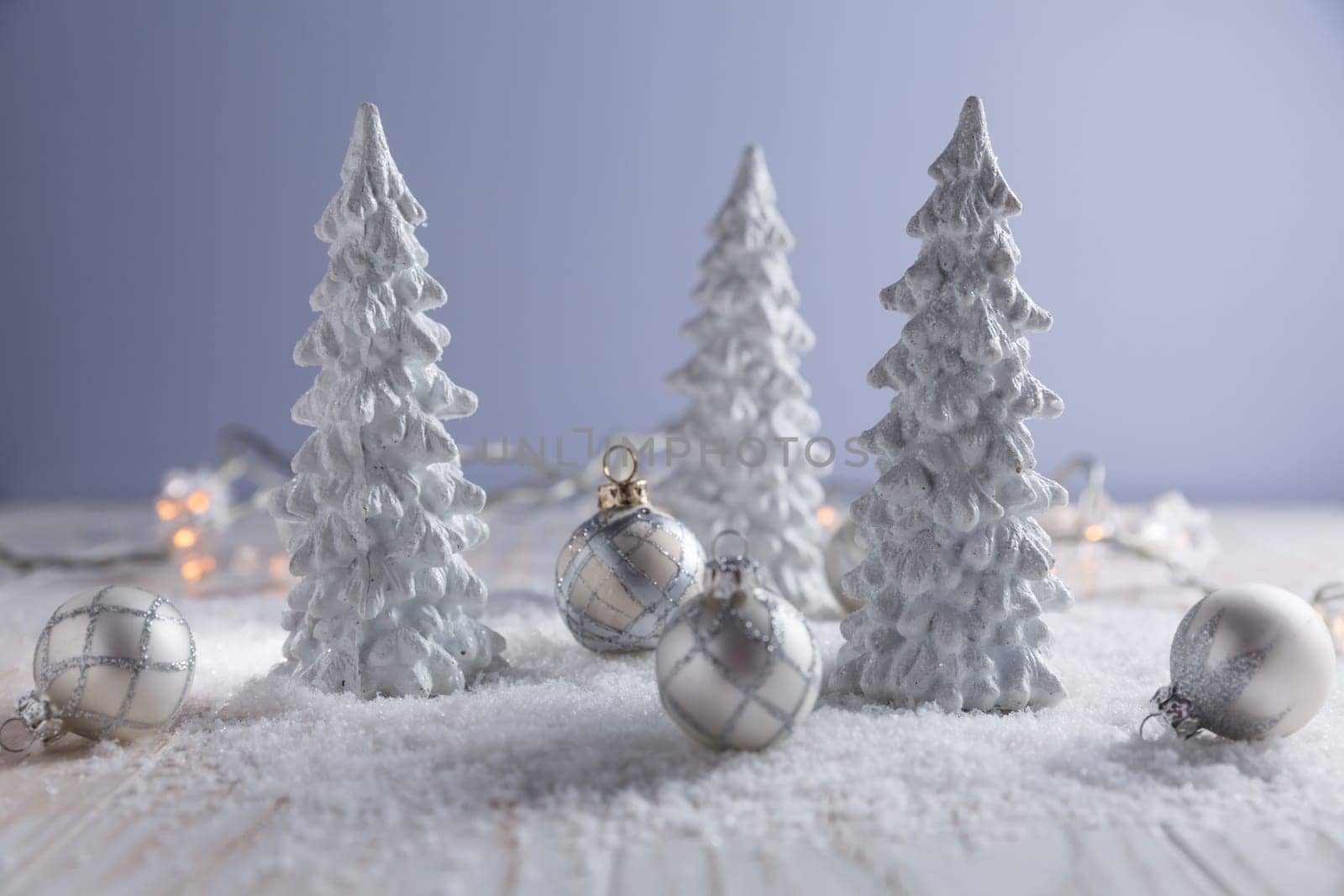 White trees with small Christmas balls as snowy landscape. Christmas decoration.