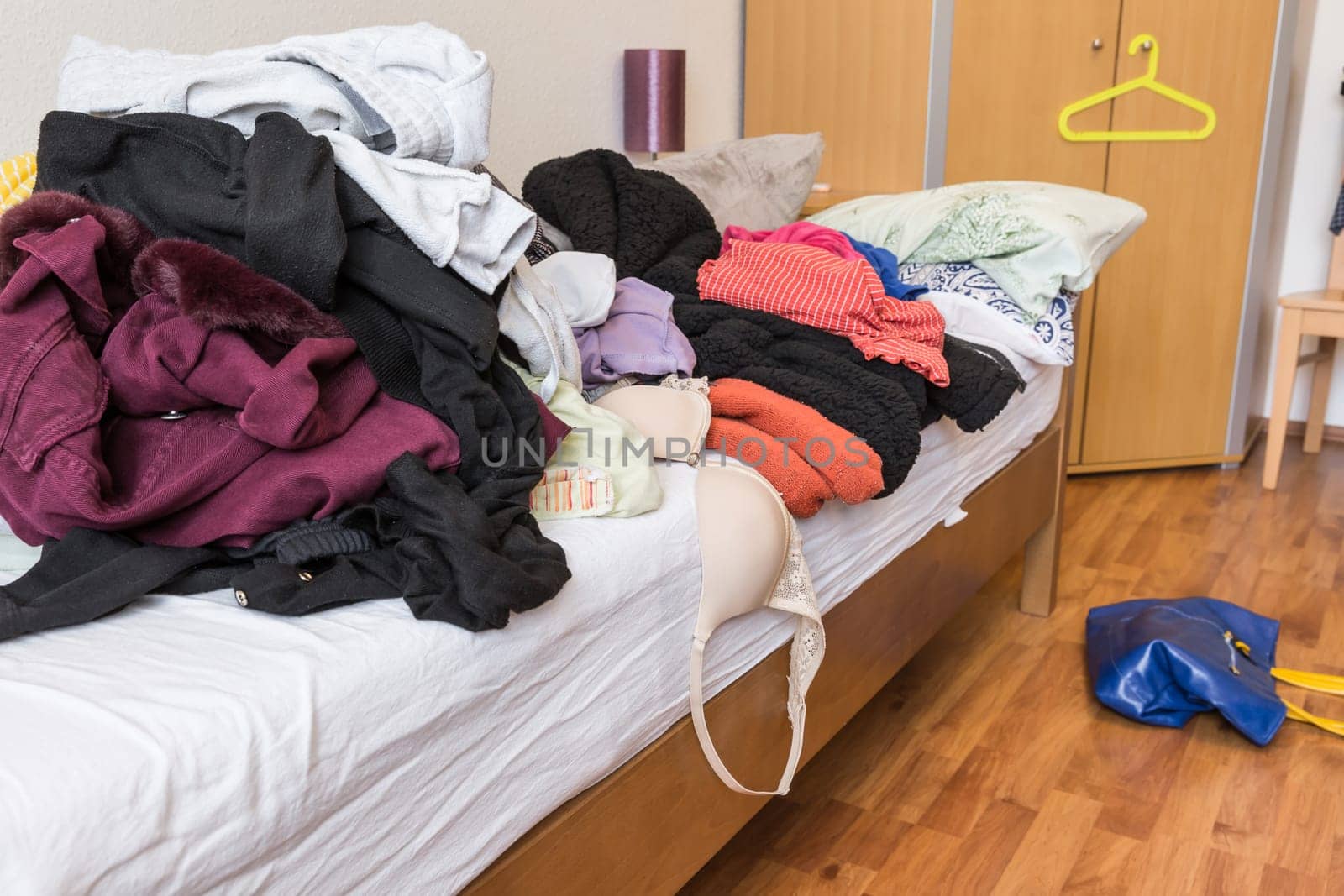 Messy teenager room. Untidy cluttered bed, dirty clothes. Compulsive Hoarding Syndrom.