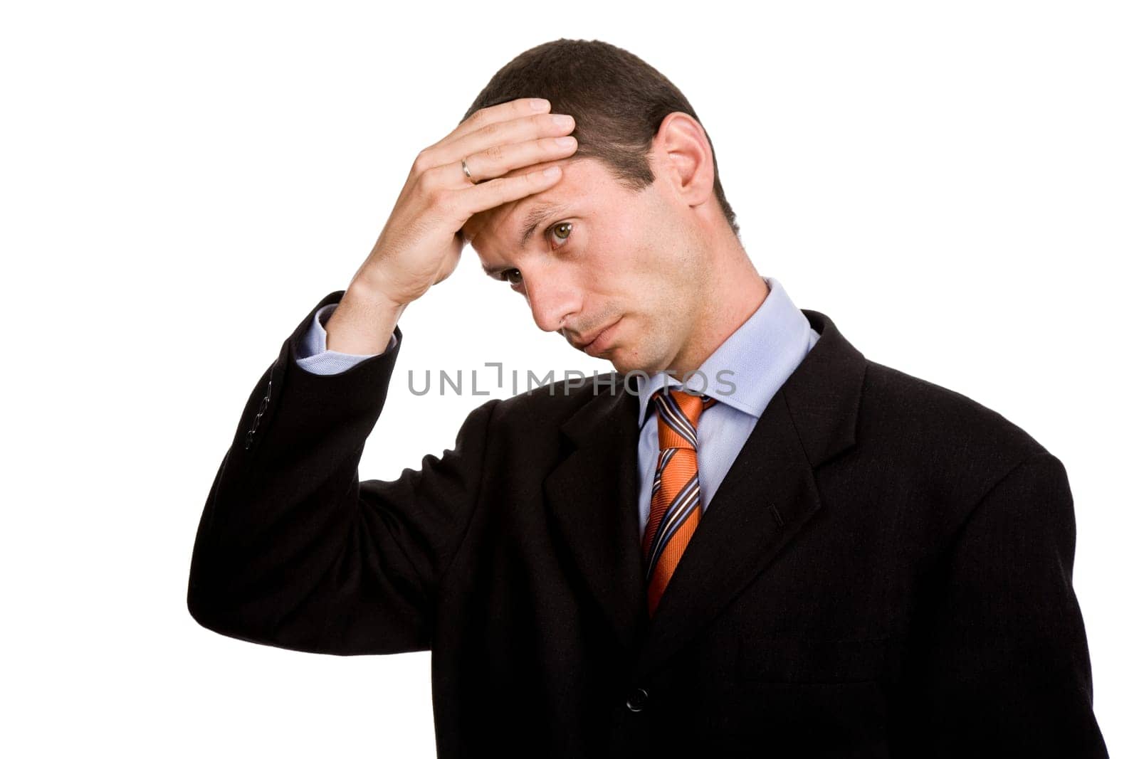 Businessman in a suit gestures with a headache
