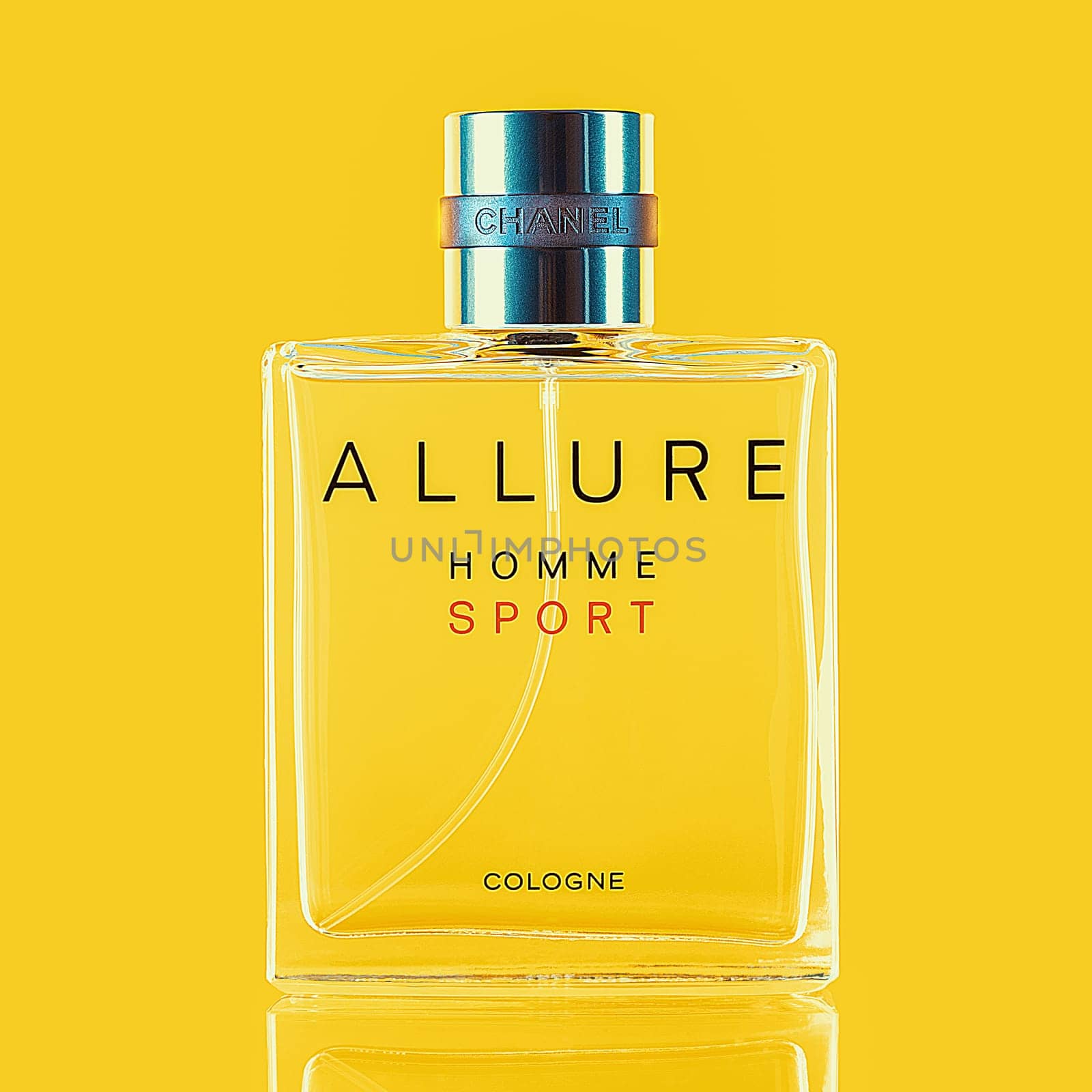 A bottle of Chanel perfume on a uniform yellow background, with a reflection of the lower part. Allure men's perfume series. Layout, layout, advertising, mockup. 2020-07-05 Samara.