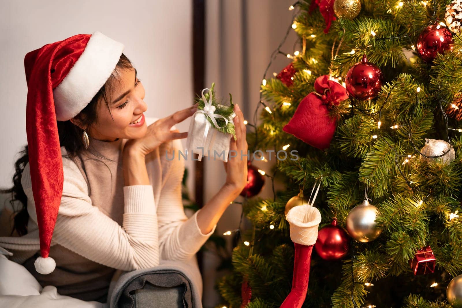 Beautiful asian woman holding Christmas ornament for decorate on christmas tree preparing for season greeting of merry christmas and happy holiday.
