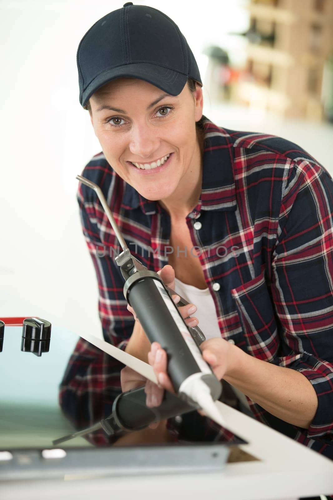 woman using silicone for gluing kitchen top