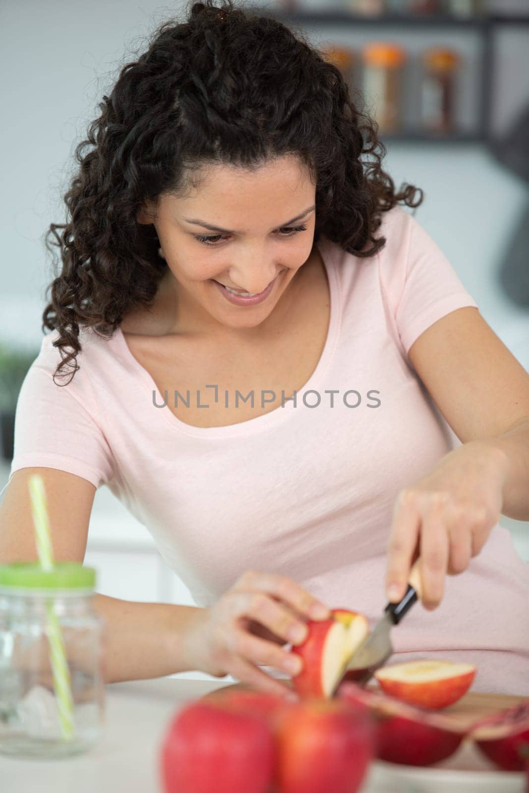 women are cutting apples in the kitchen