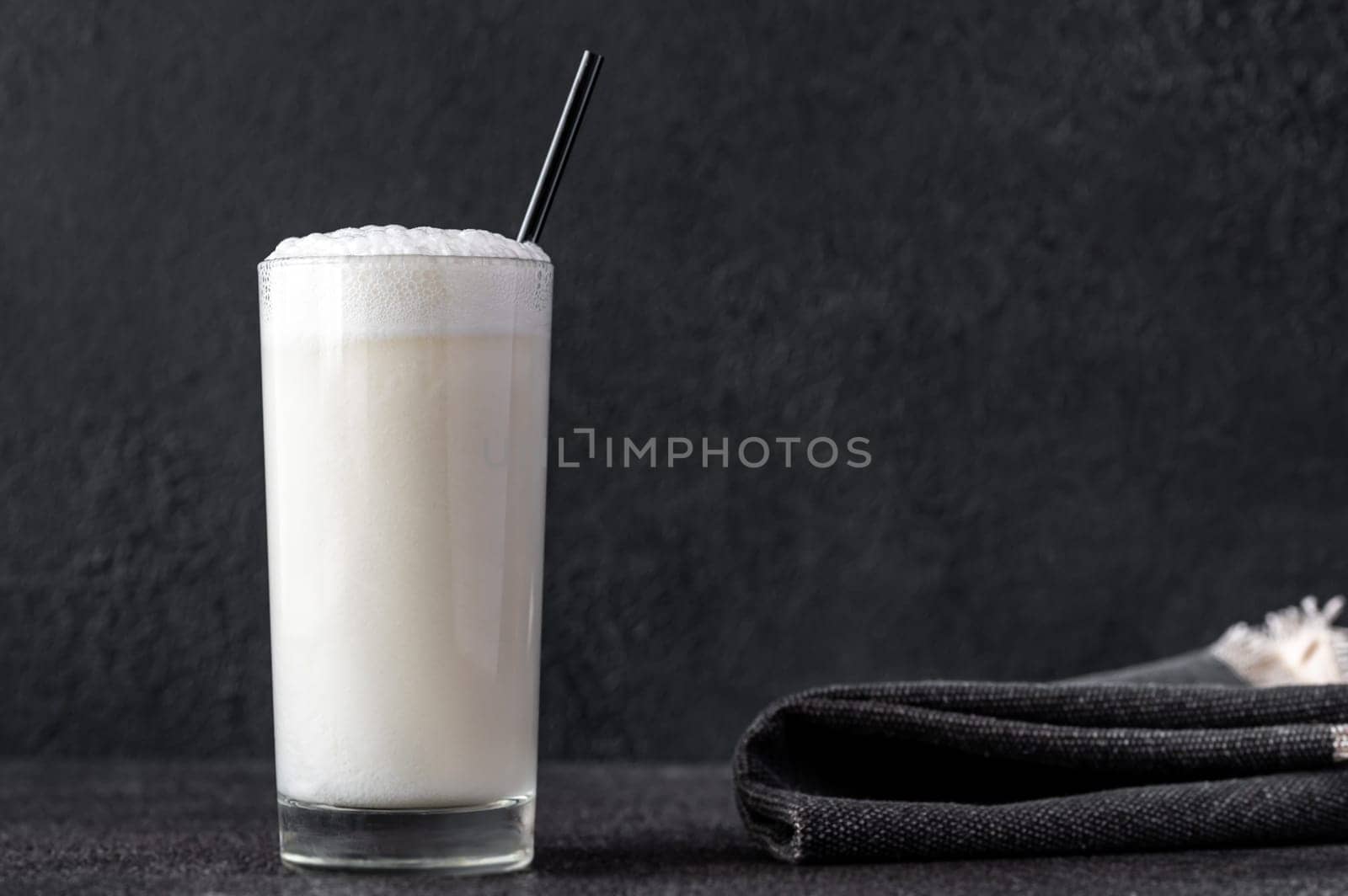 Glass of Ramos Gin Fizz Cocktail on dark background