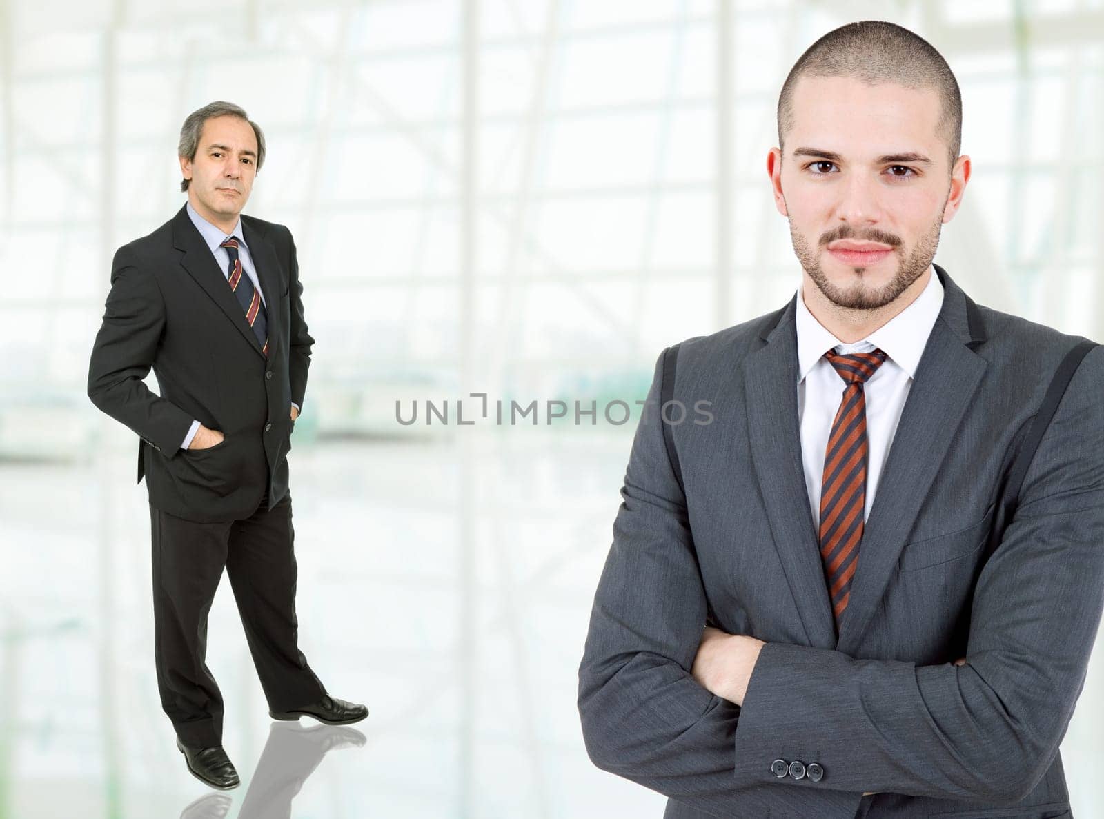 two business men standing at the office