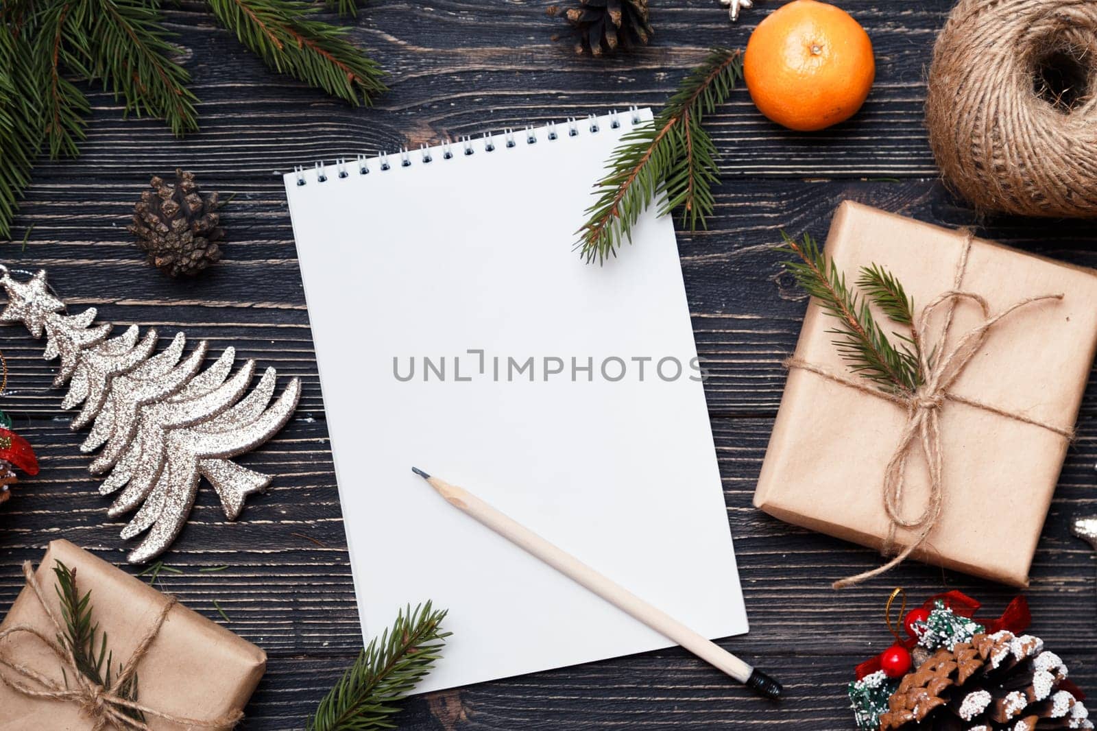 Letter to Santa Claus, Christmas gifts on dark wooden background.