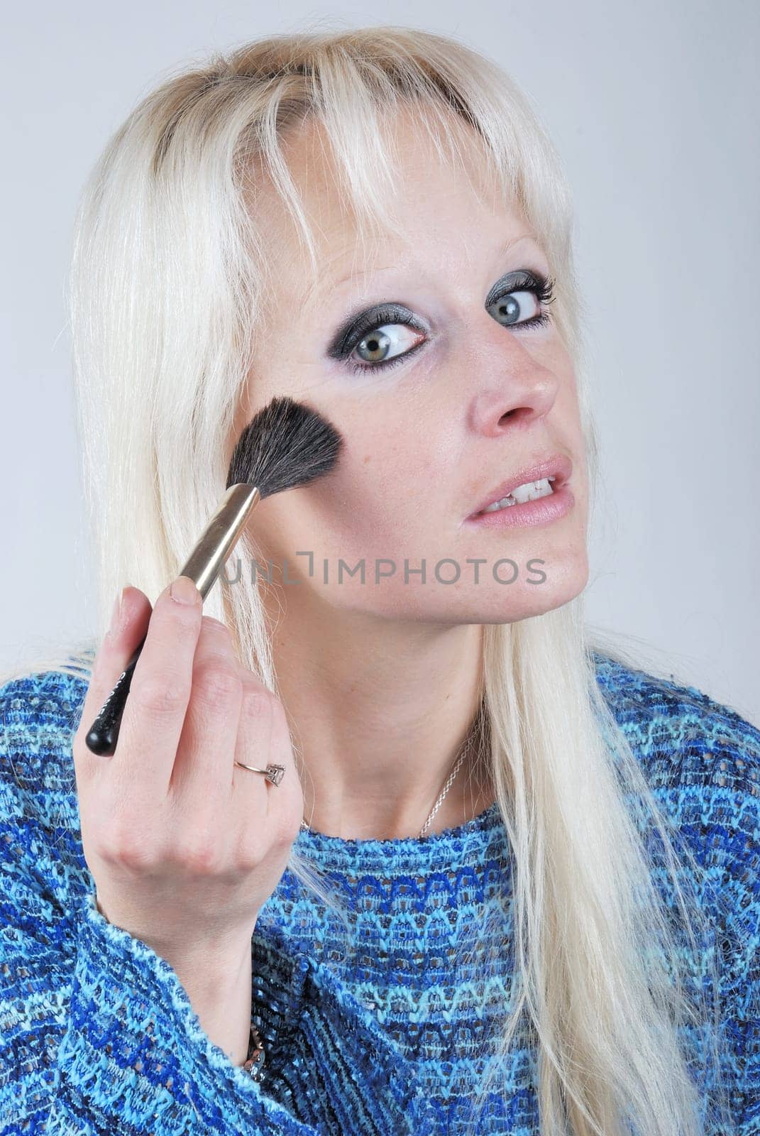 Woman applying makeup