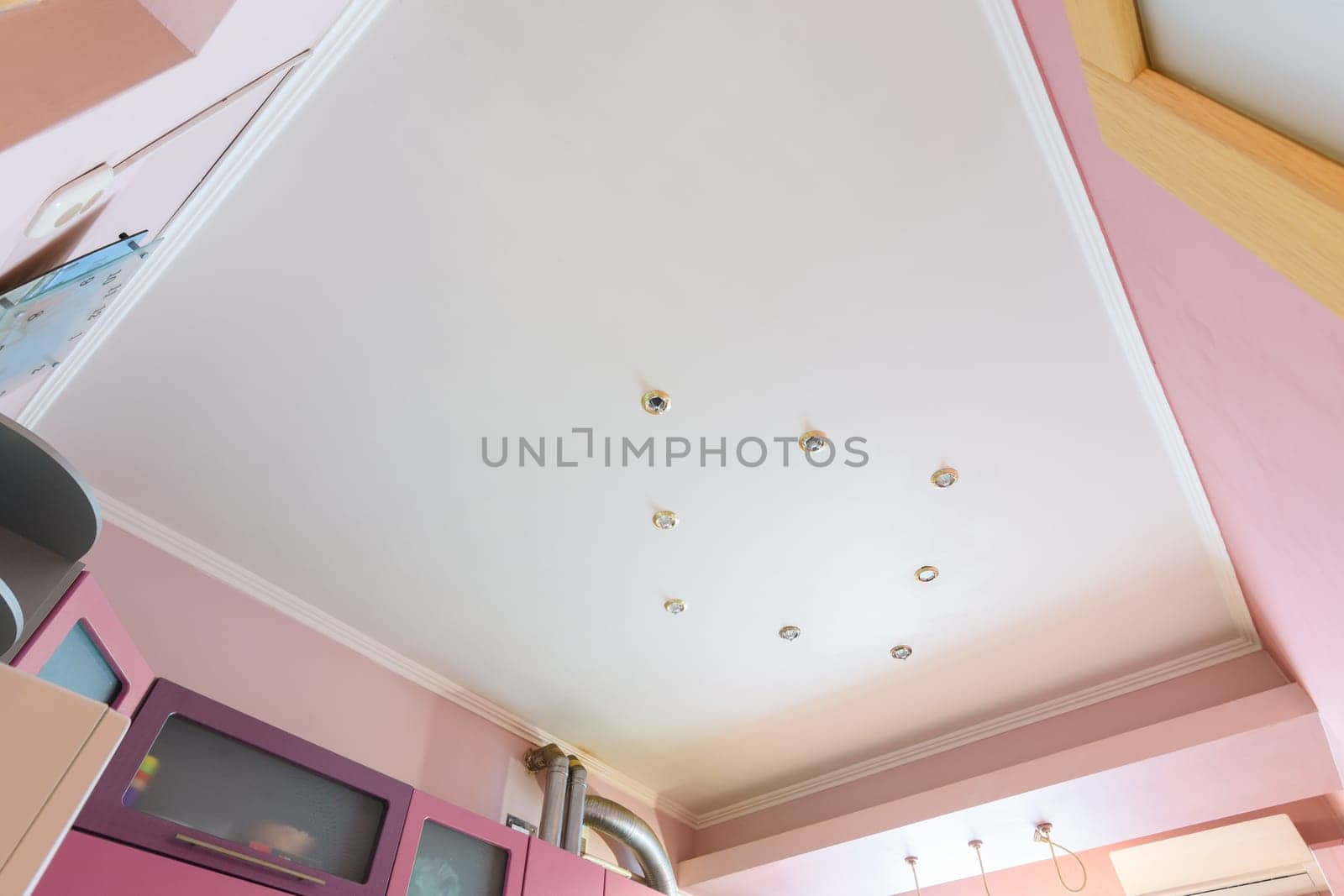 Stretch matte ceiling in the interior of the kitchen, the light is off
