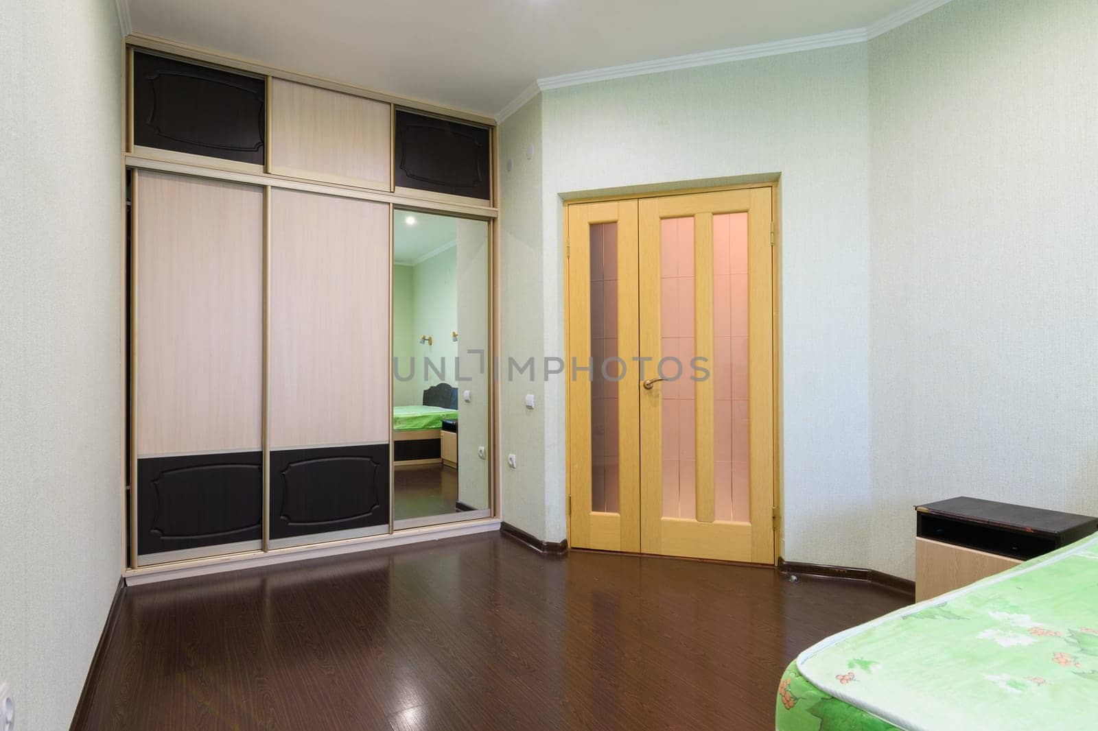Fragment of the bedroom interior, view of the wardrobe and the interior door