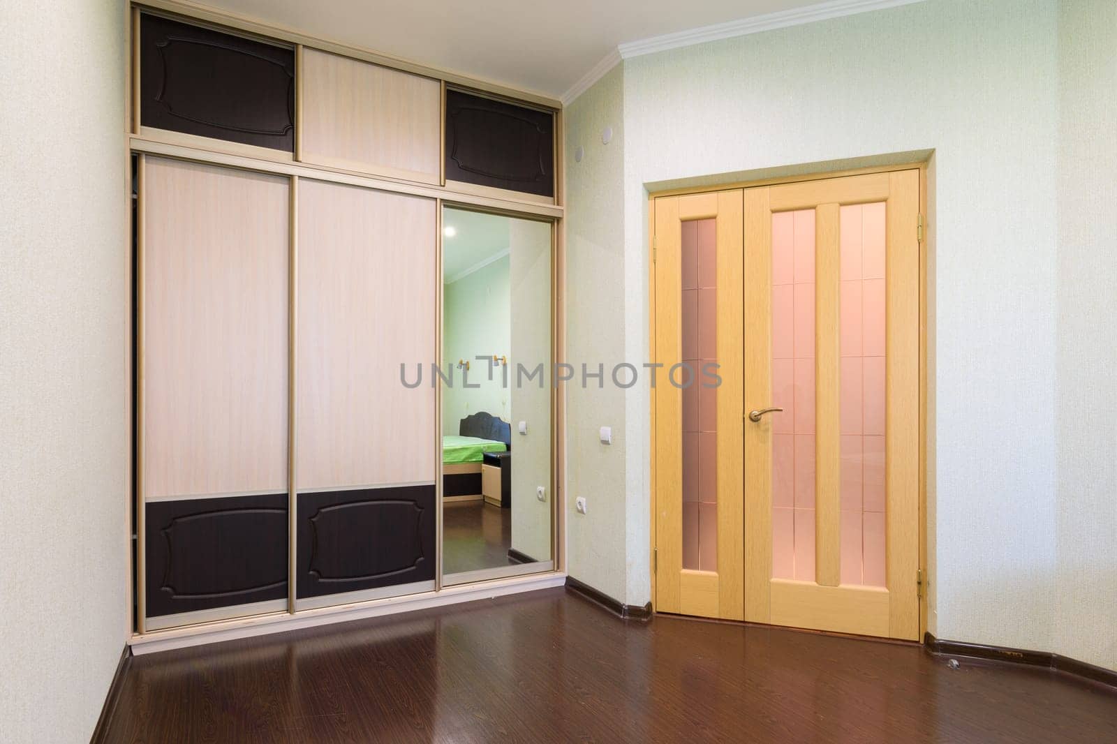 Fragment of the bedroom interior, view of the wardrobe and the interior door