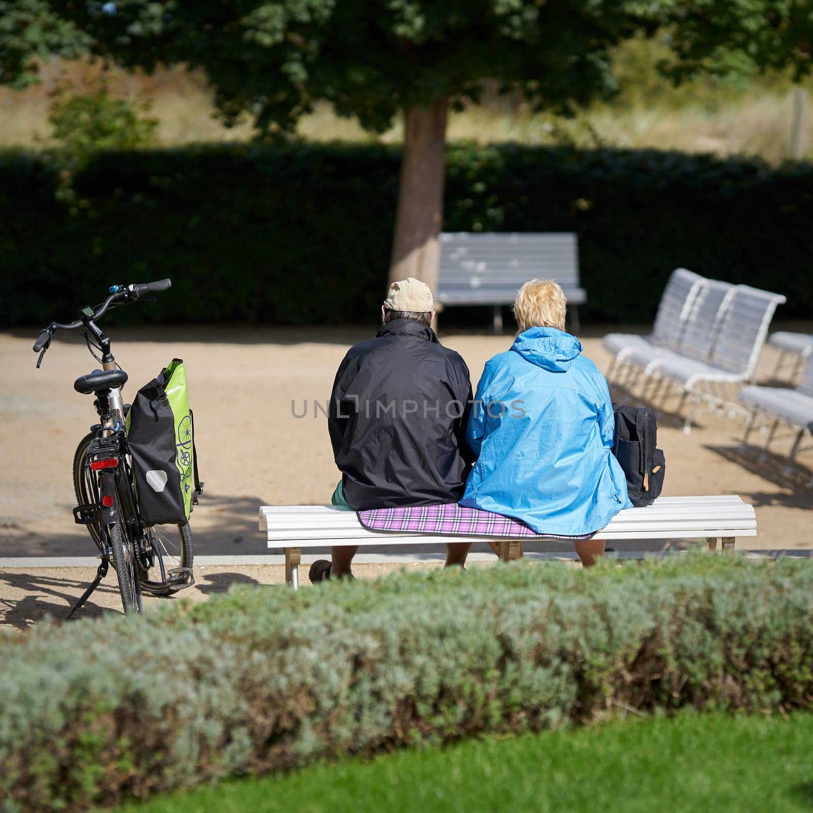 Pensioner couple on a park bench on the beach promenade in Heringsdorf on the German Baltic Sea coast