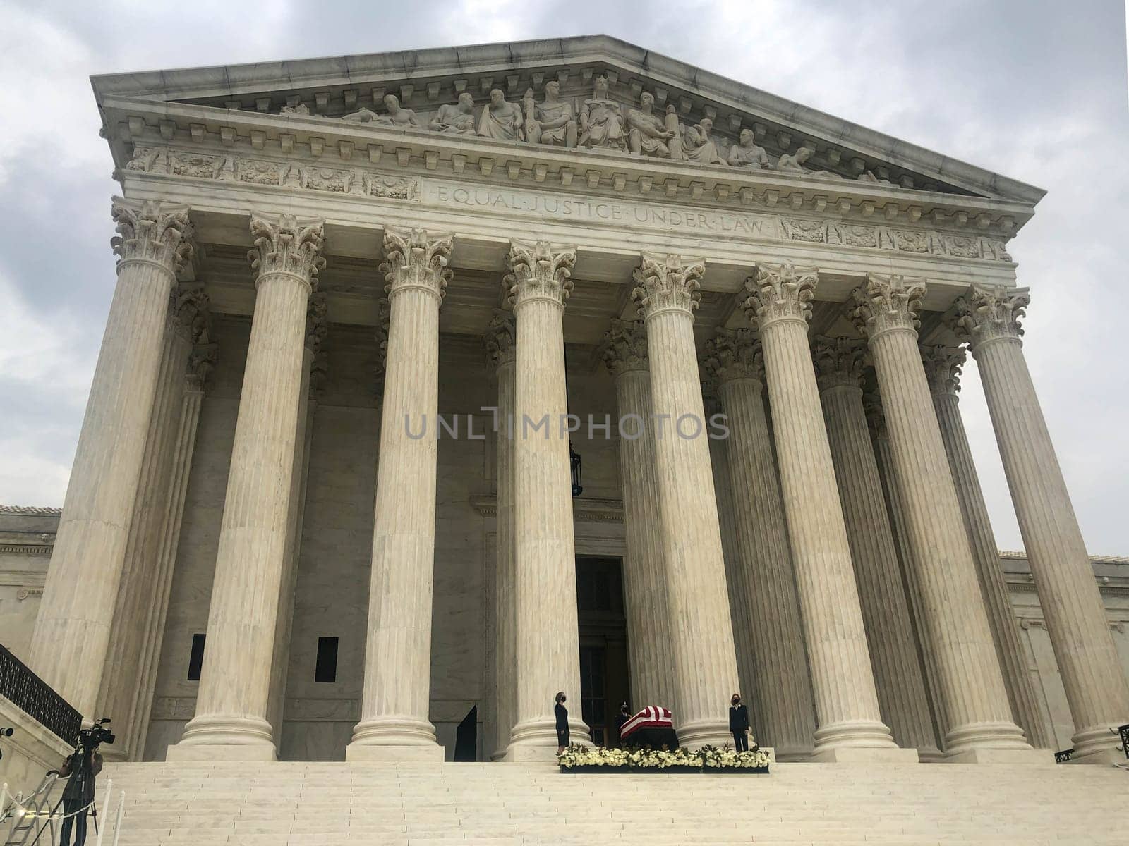 Pallbearers in face masks stand by the casket of Justice Ruth Bader Ginsburg on the steps of the Supreme Court. Editorial use.