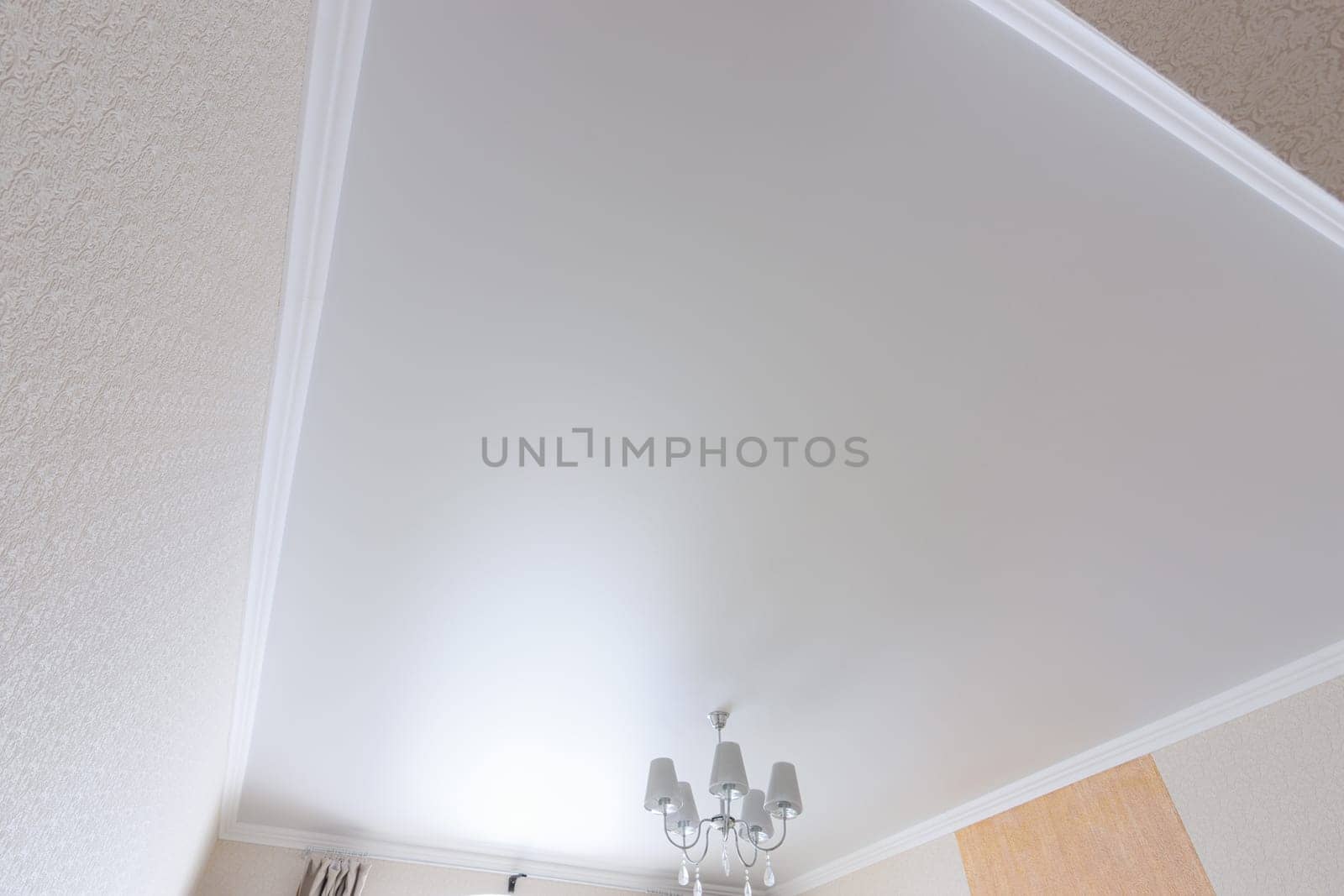White matte ceiling in a large room close up