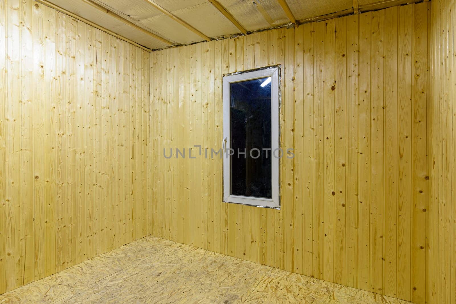 Walls finished with wooden clapboard in the interior of a country empty house