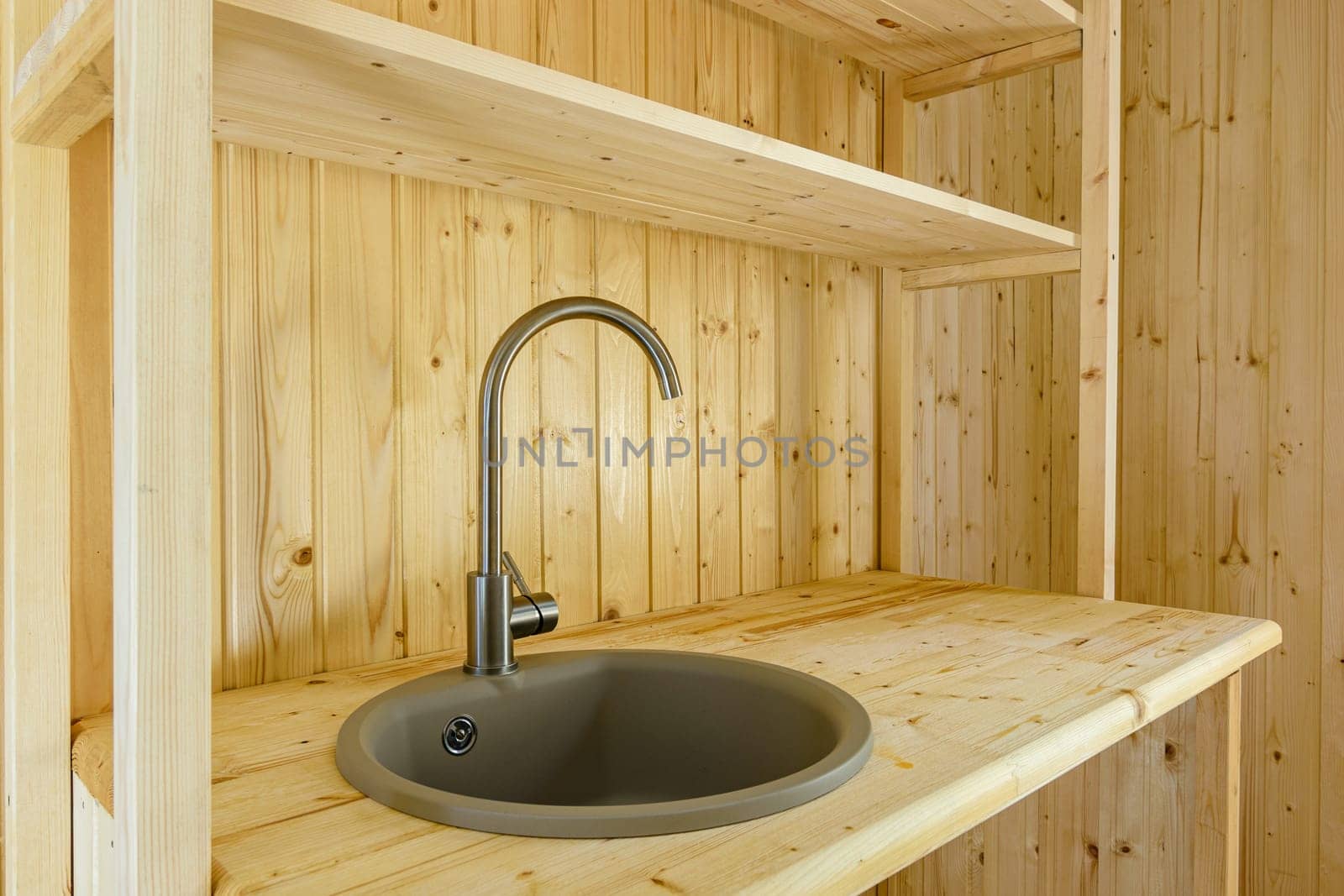 Kitchen set in a country house, worktop and walls made of natural wood