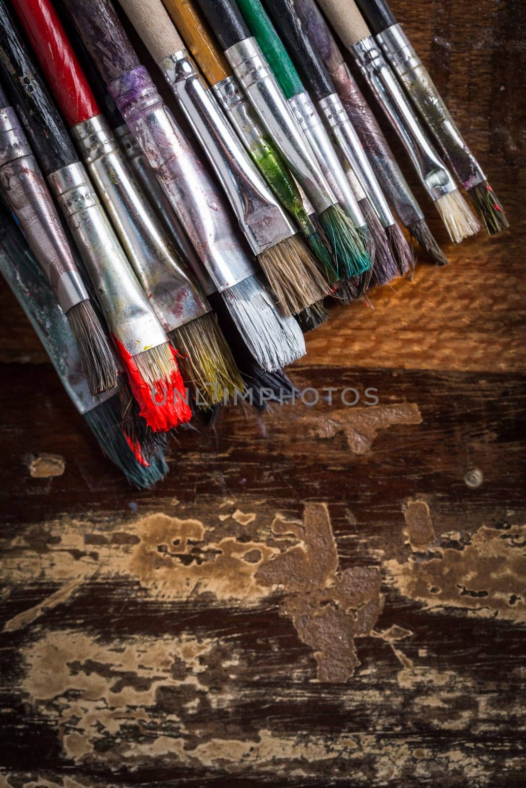 Artist vintage paint brushes on wooden background.