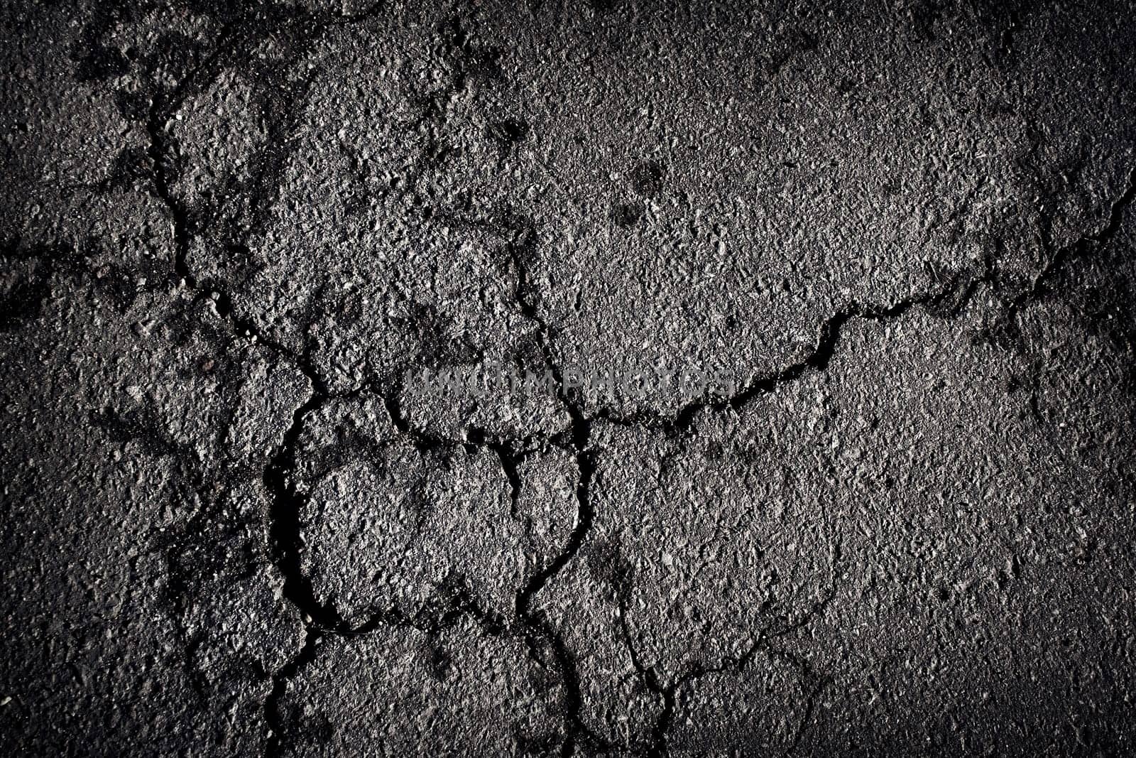 Cracked asphalt texture outdoors on the road