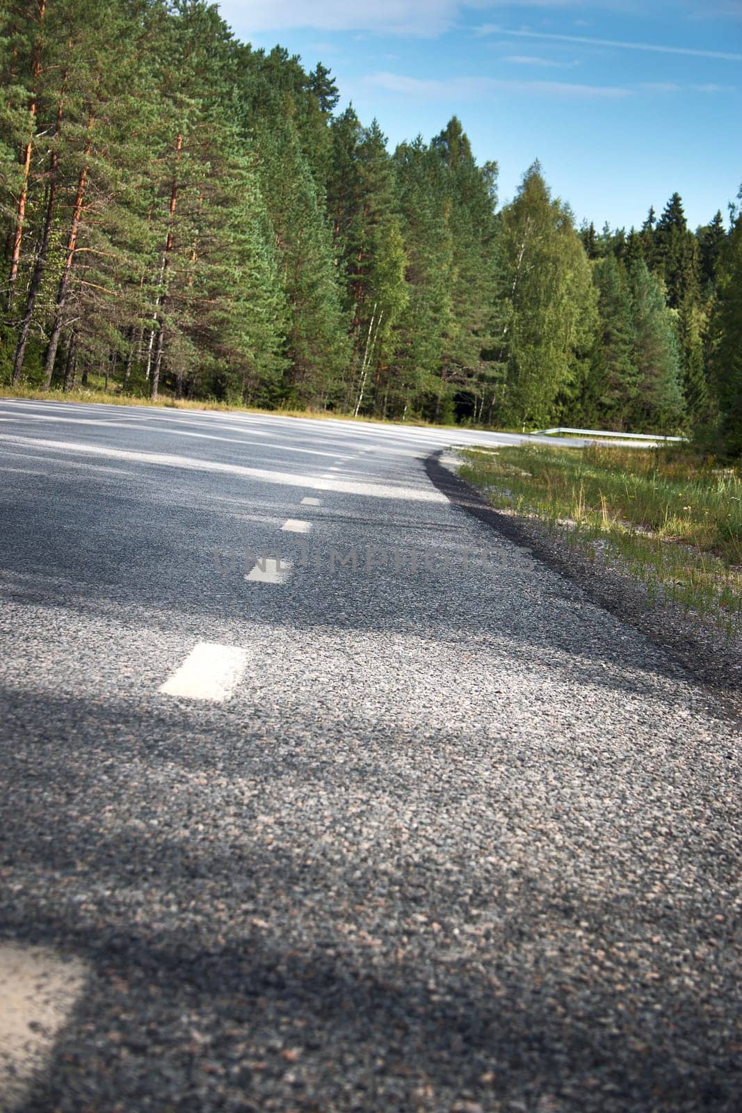 black asphalt road and white dividing lines