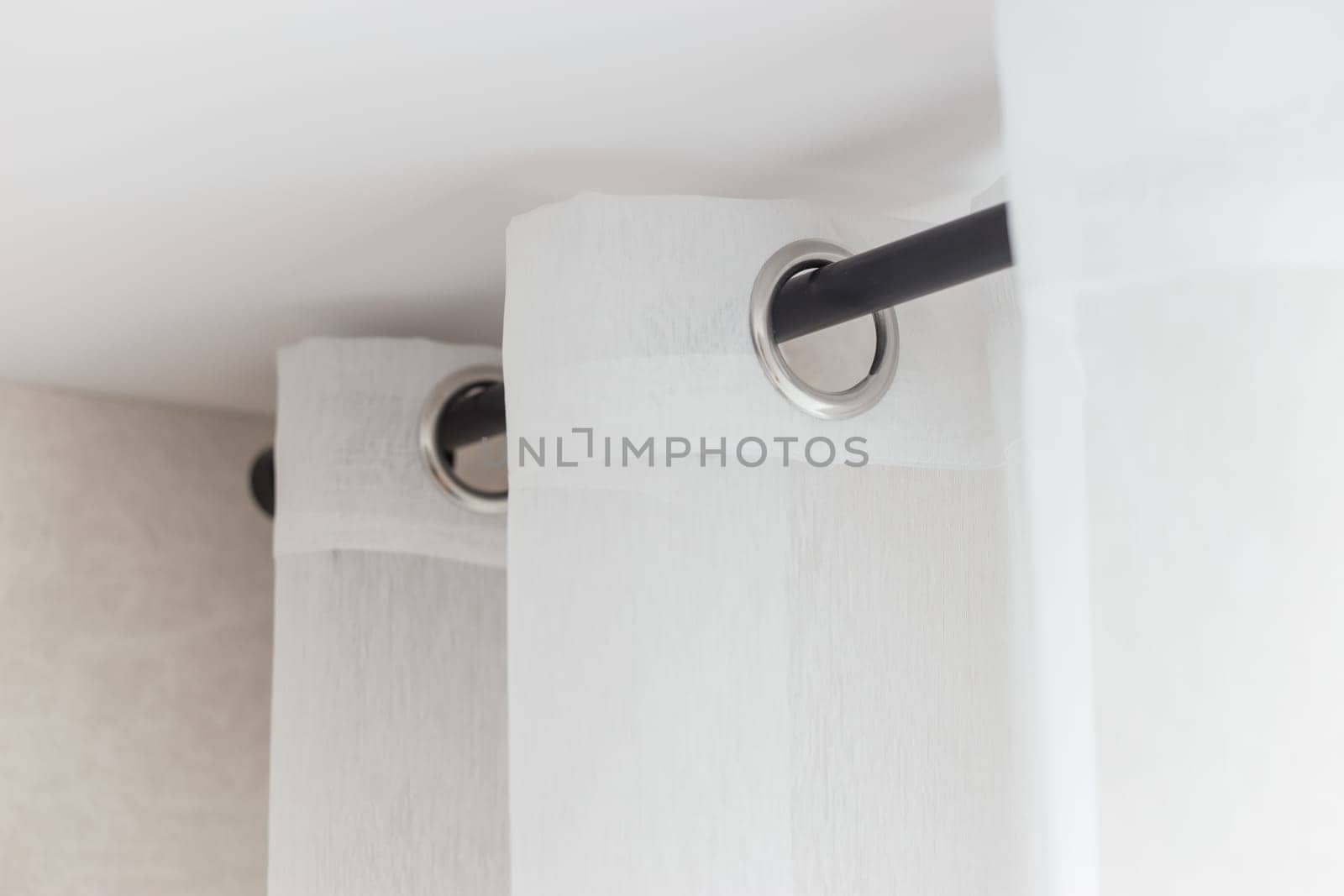 The white curtains with ring-top rail