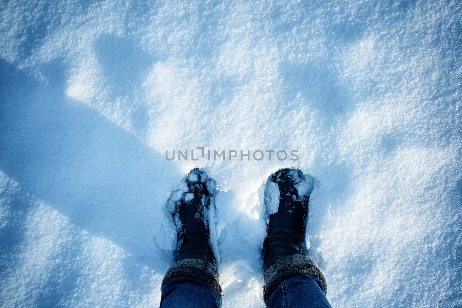 Feet on the snow outdoors on frosty winter