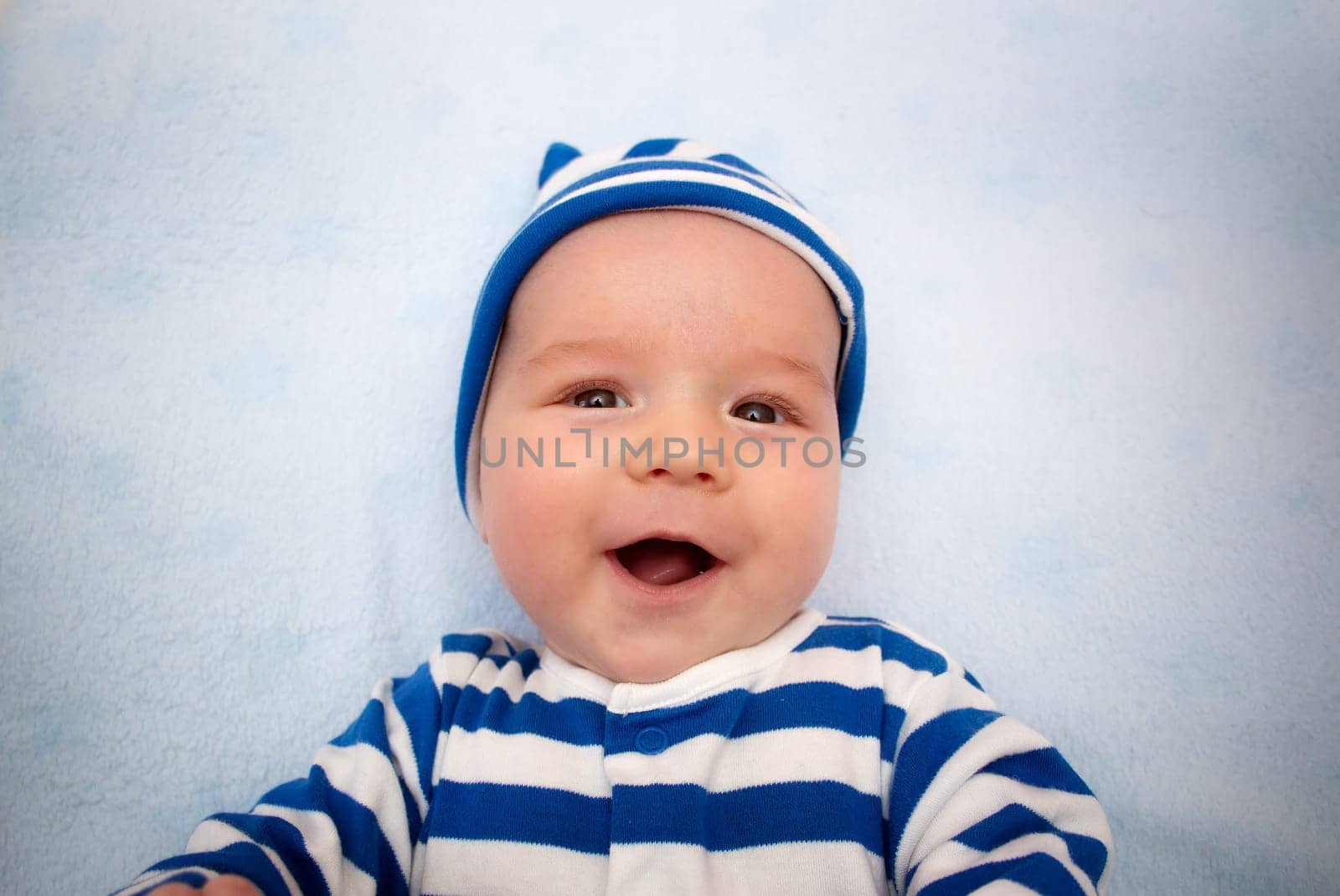3 month old baby lying in blue blanket