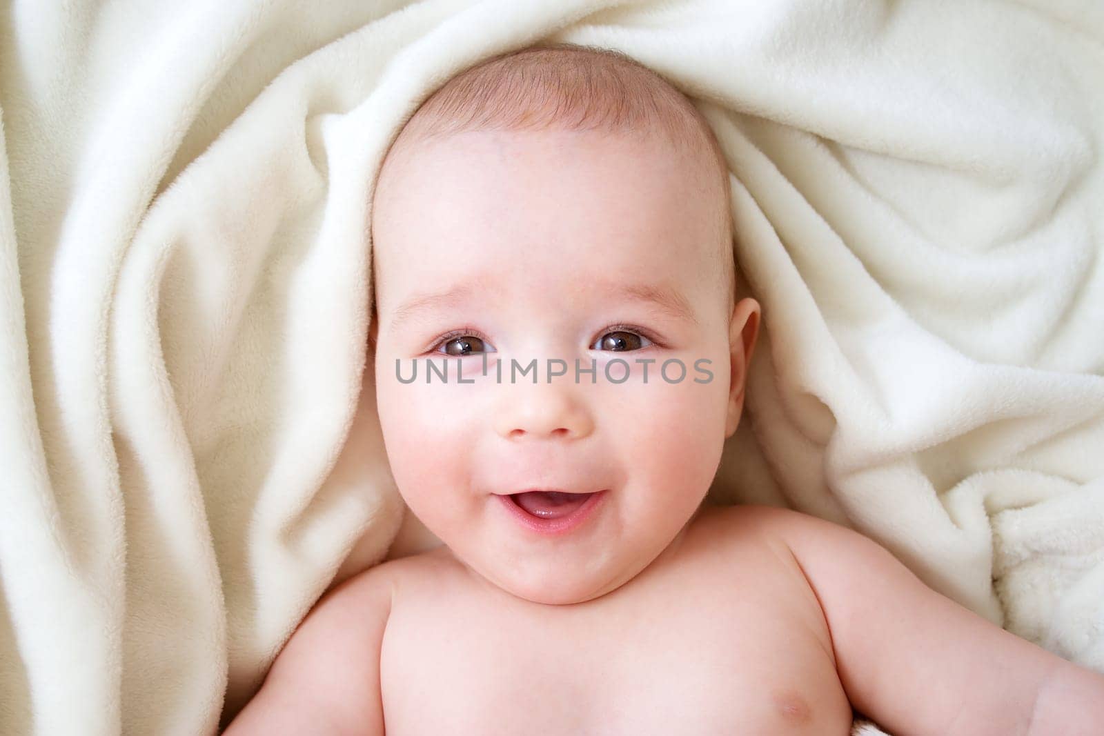 little boy sleeping on soft white blanket