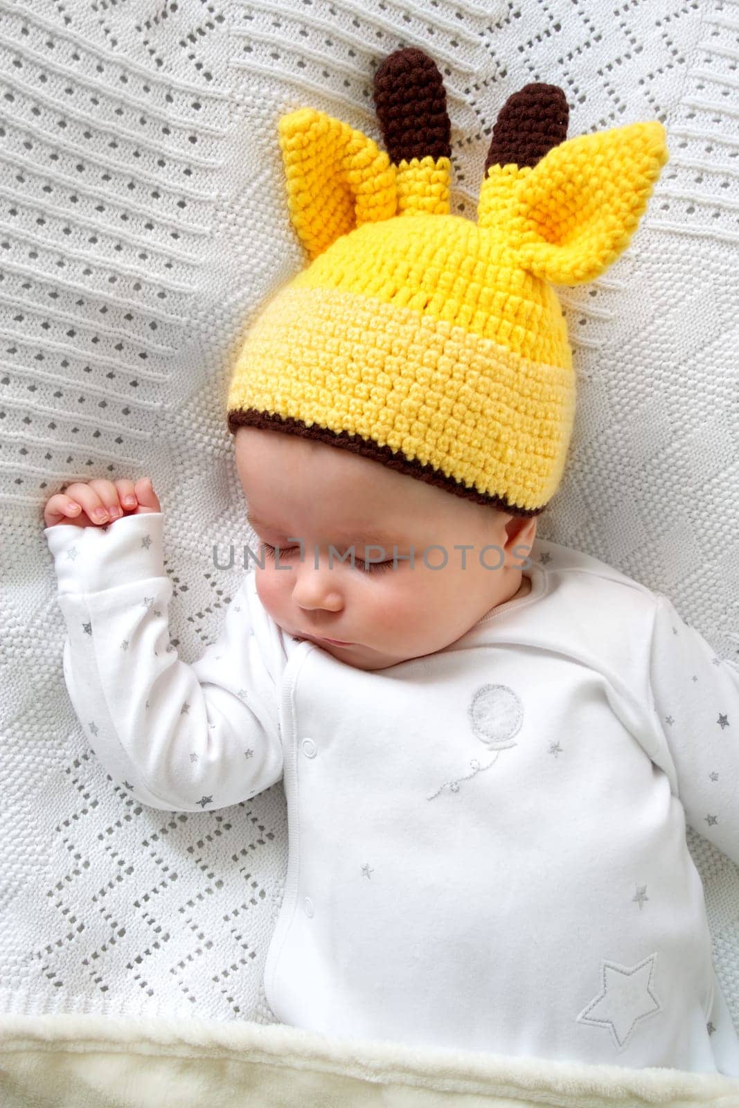 little boy sleeping on soft white blanket