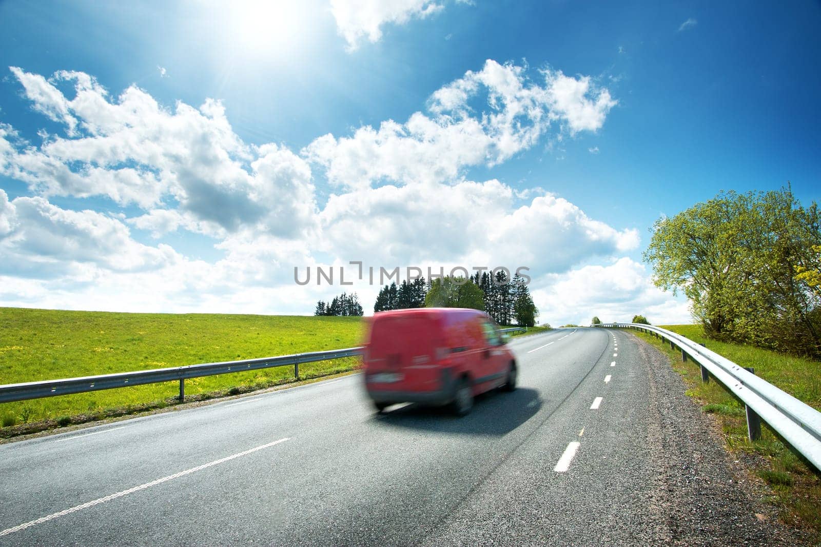 Red car on asphalt rpad on sunny day