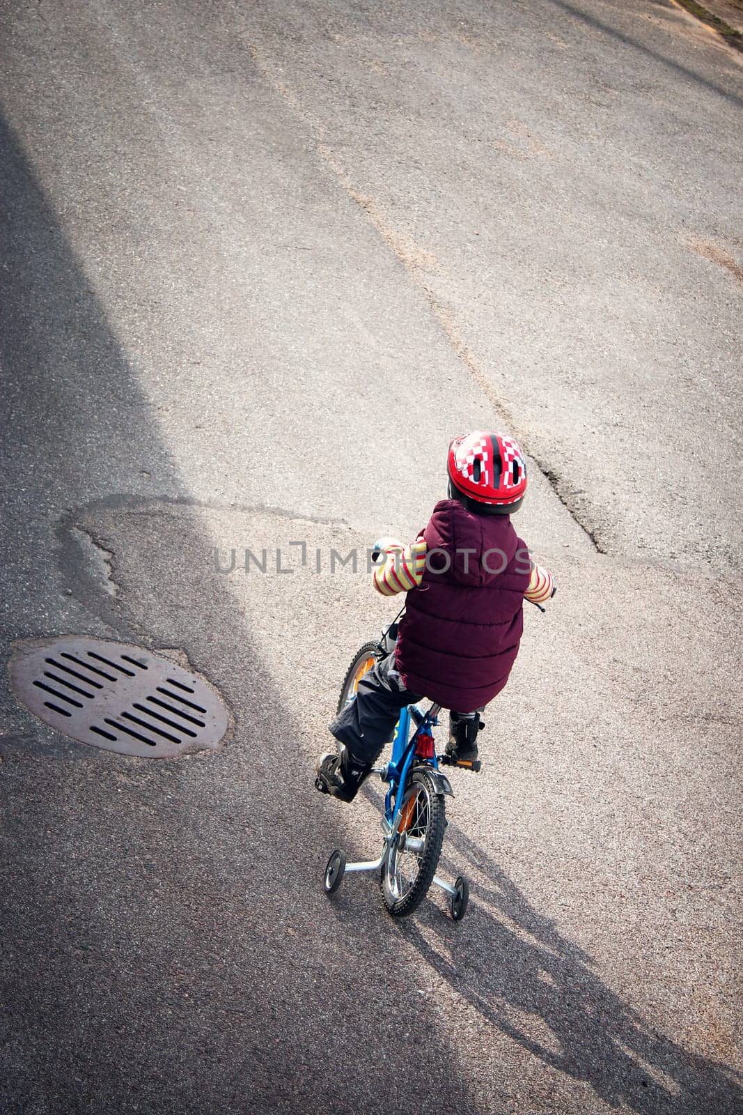Boy on bike at asphalt road in spring