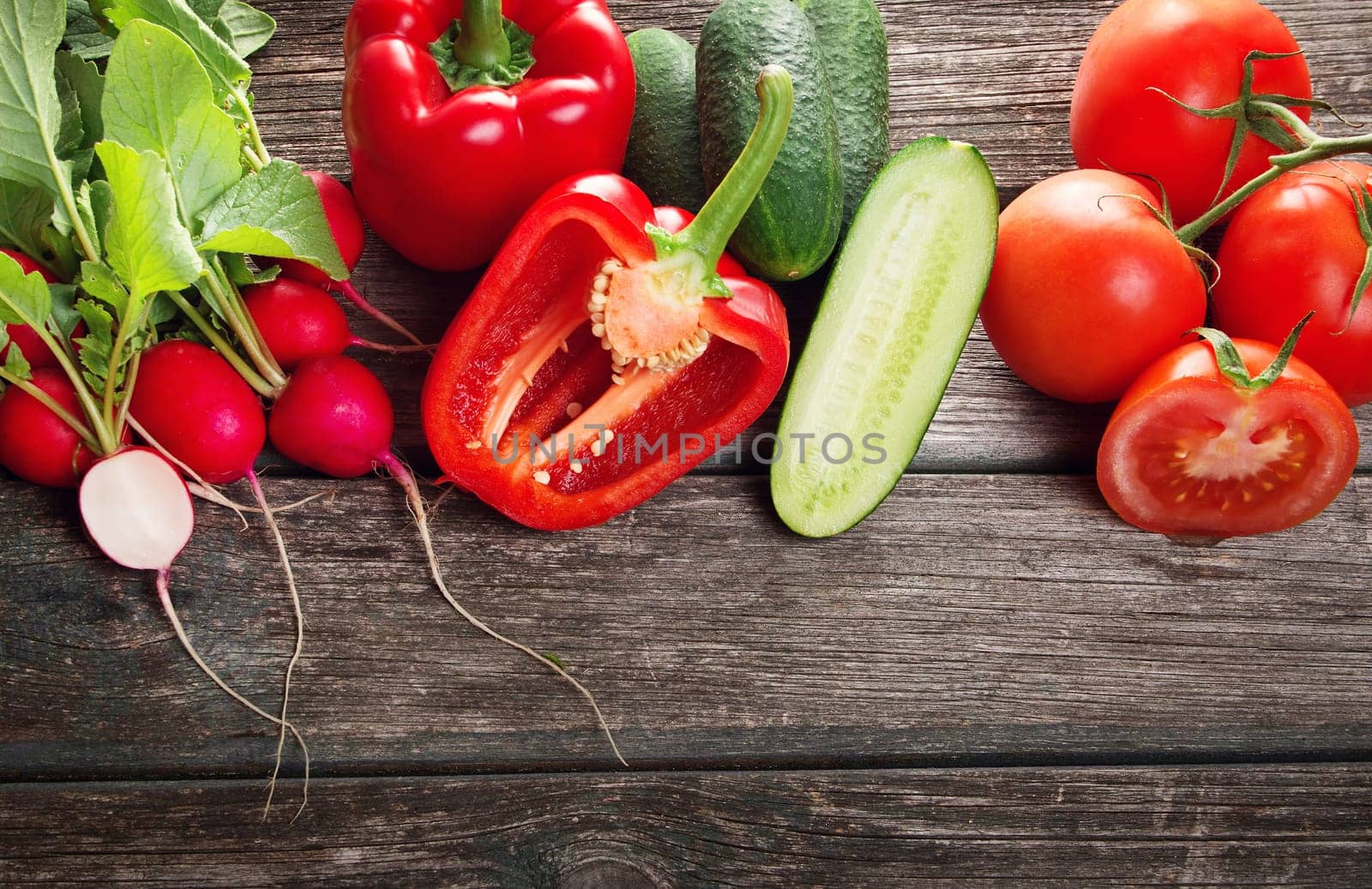 Fresh red potatoes on old wooden background