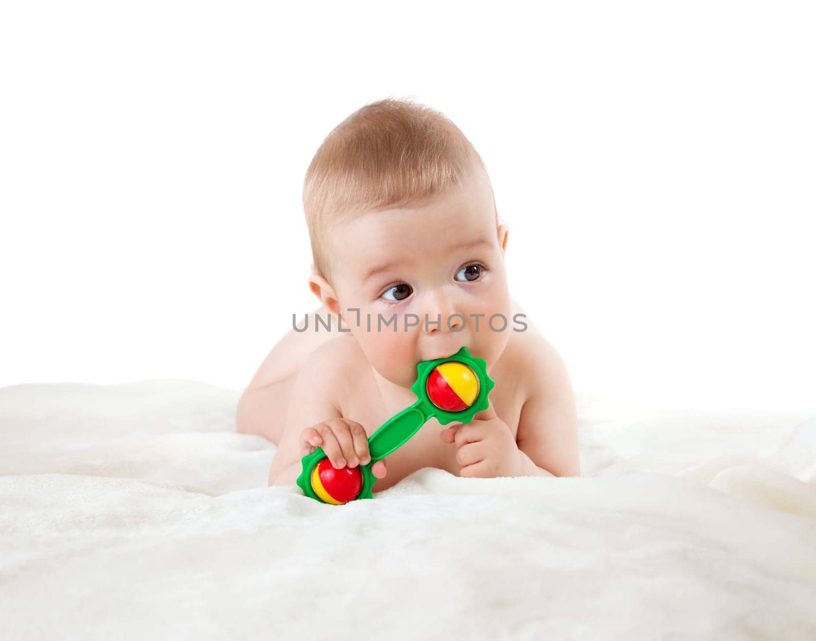 Baby holding a toy isolated on white background