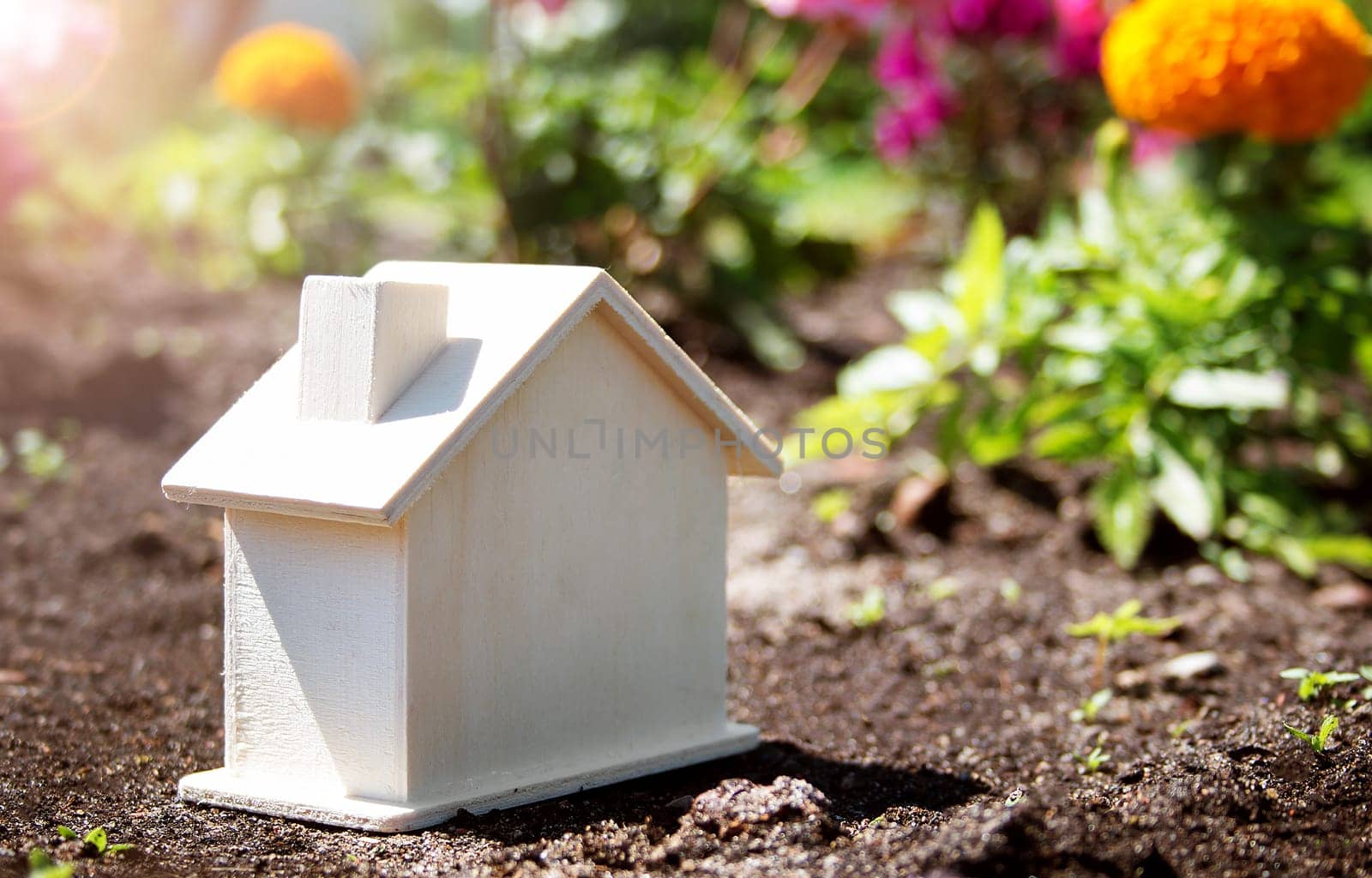 wooden house toy on the grass in garden