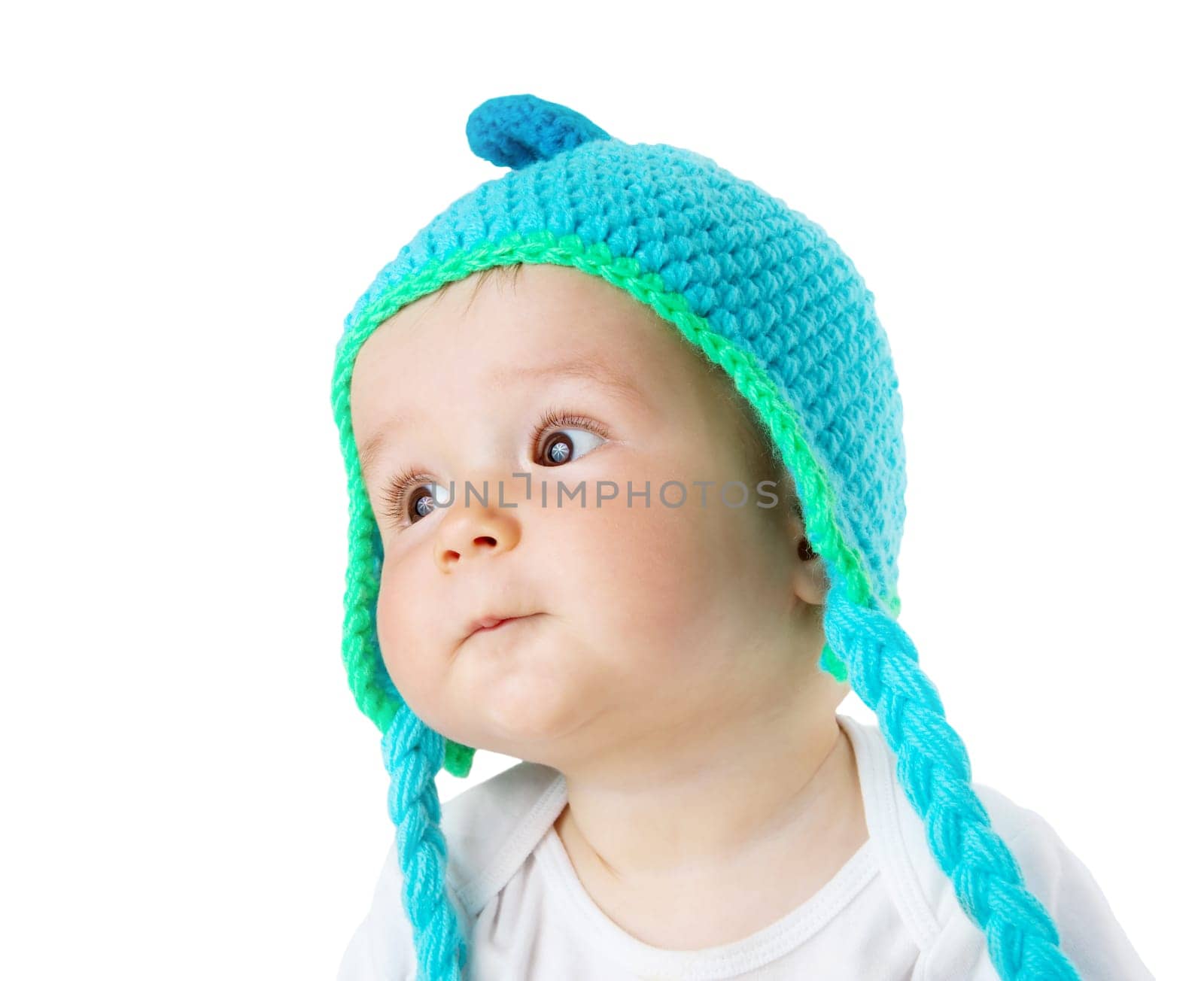 little baby in knitted monkey hat on brown blanket