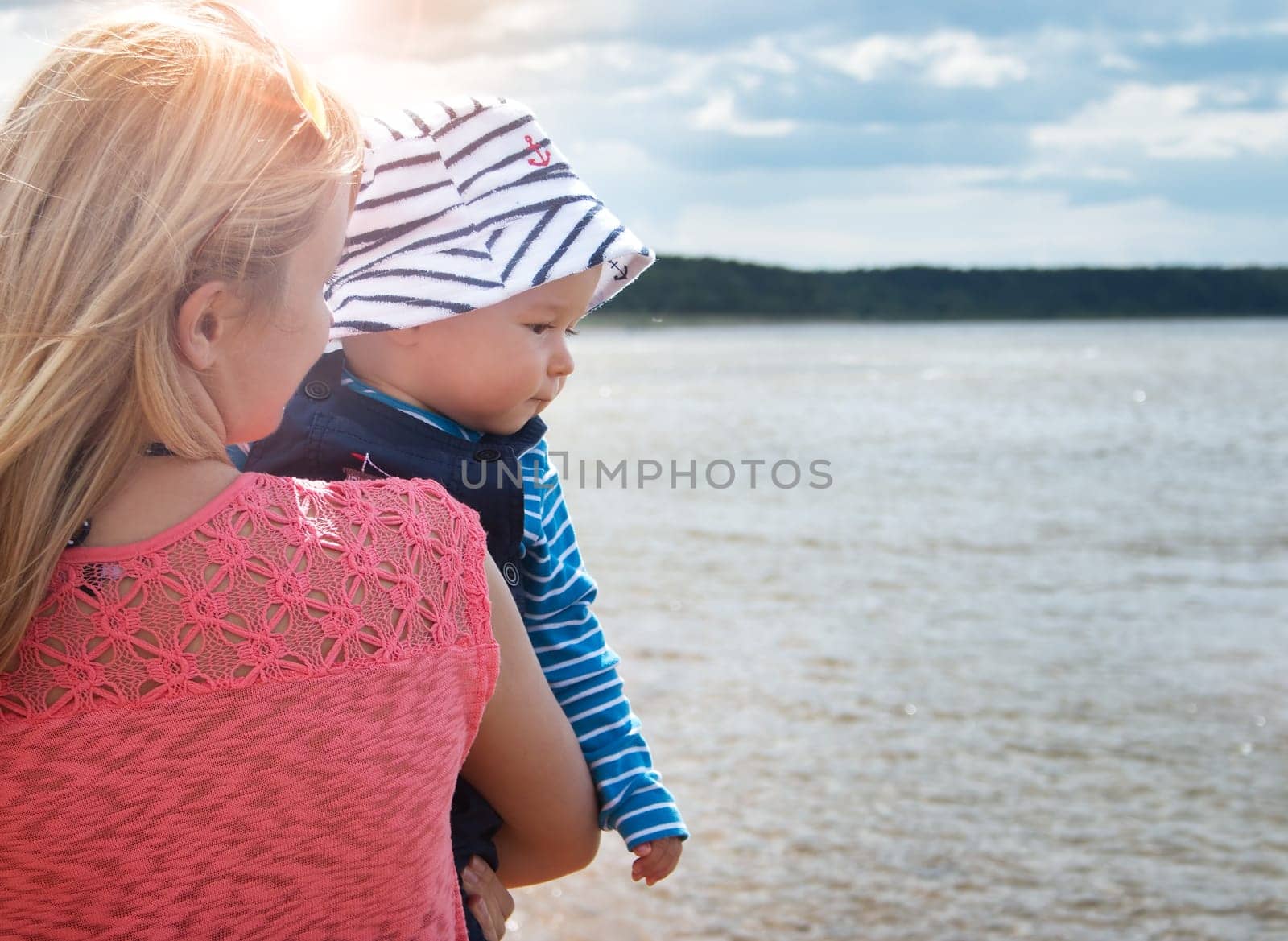 young woman and baby at the beach near sea