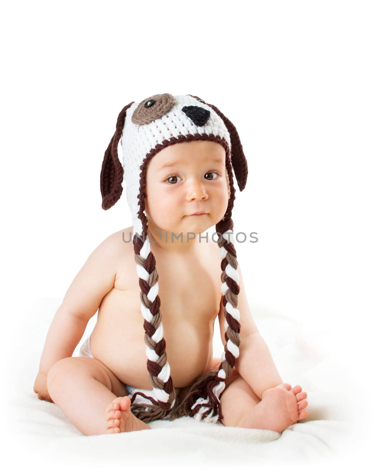 cute baby in dog hat sitting isolated on white background