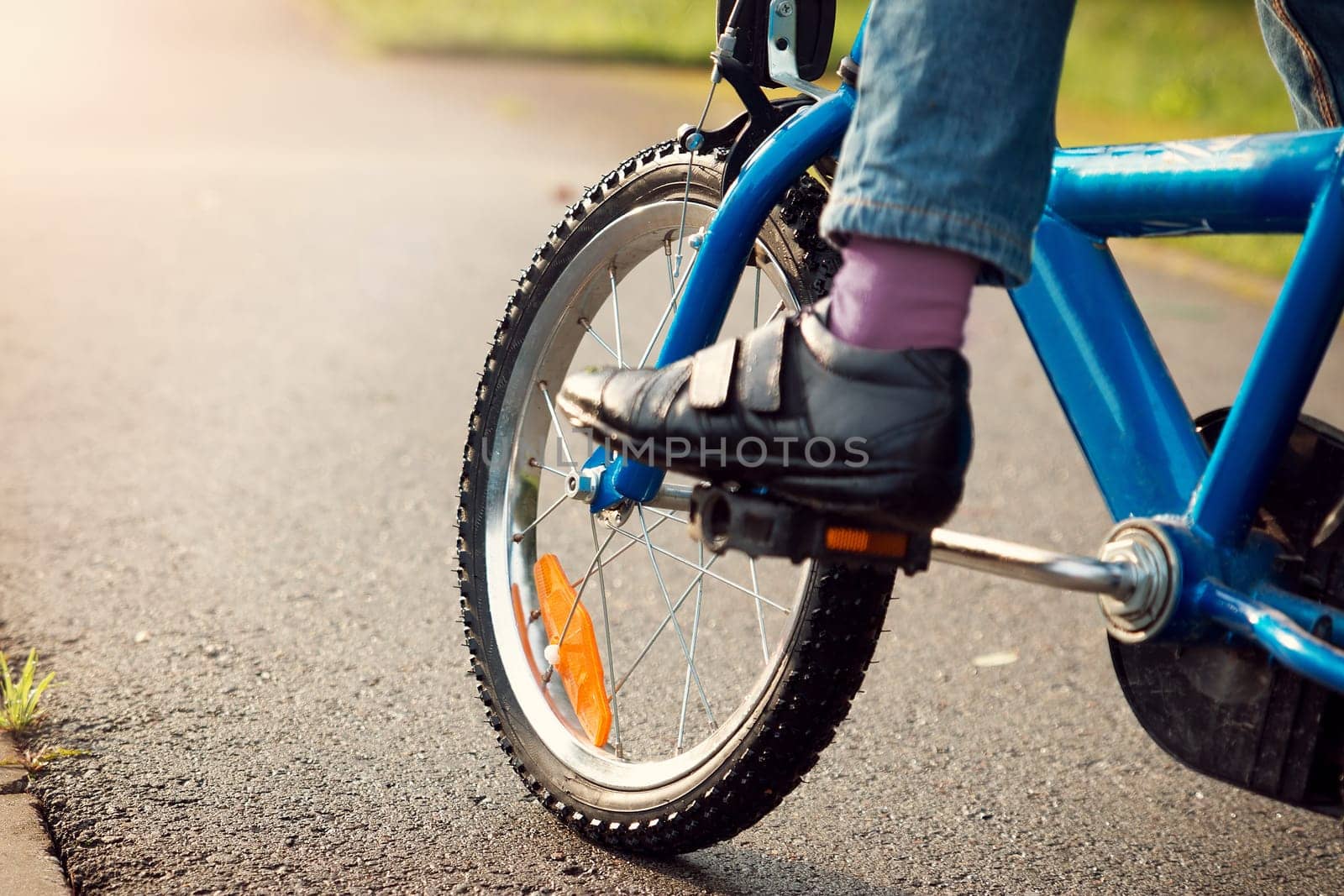 a child on a bicycle in part on asphalt road