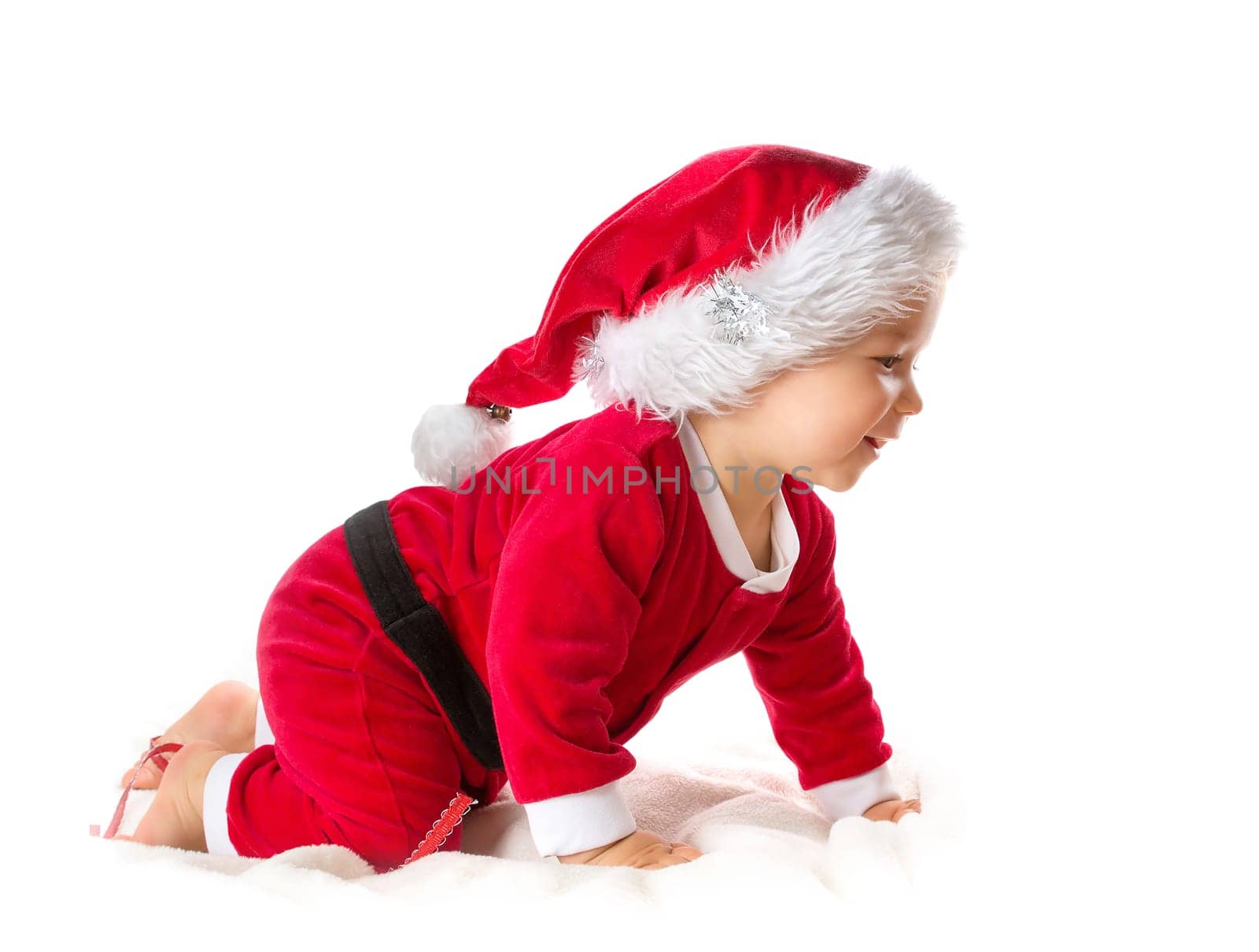 Baby isolated on white background crawling in santa costume