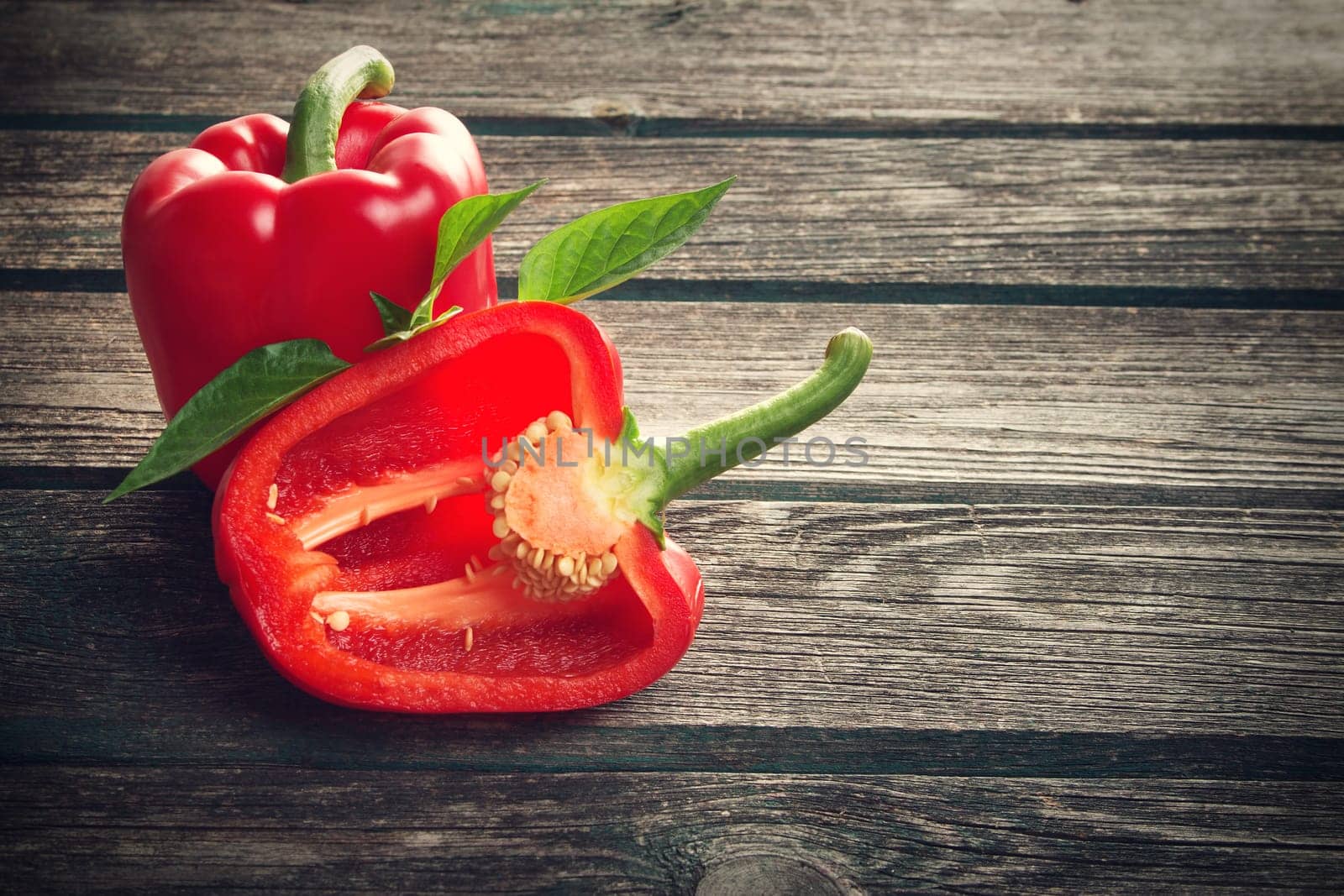 Fresh sweet red pepper on old wooden background