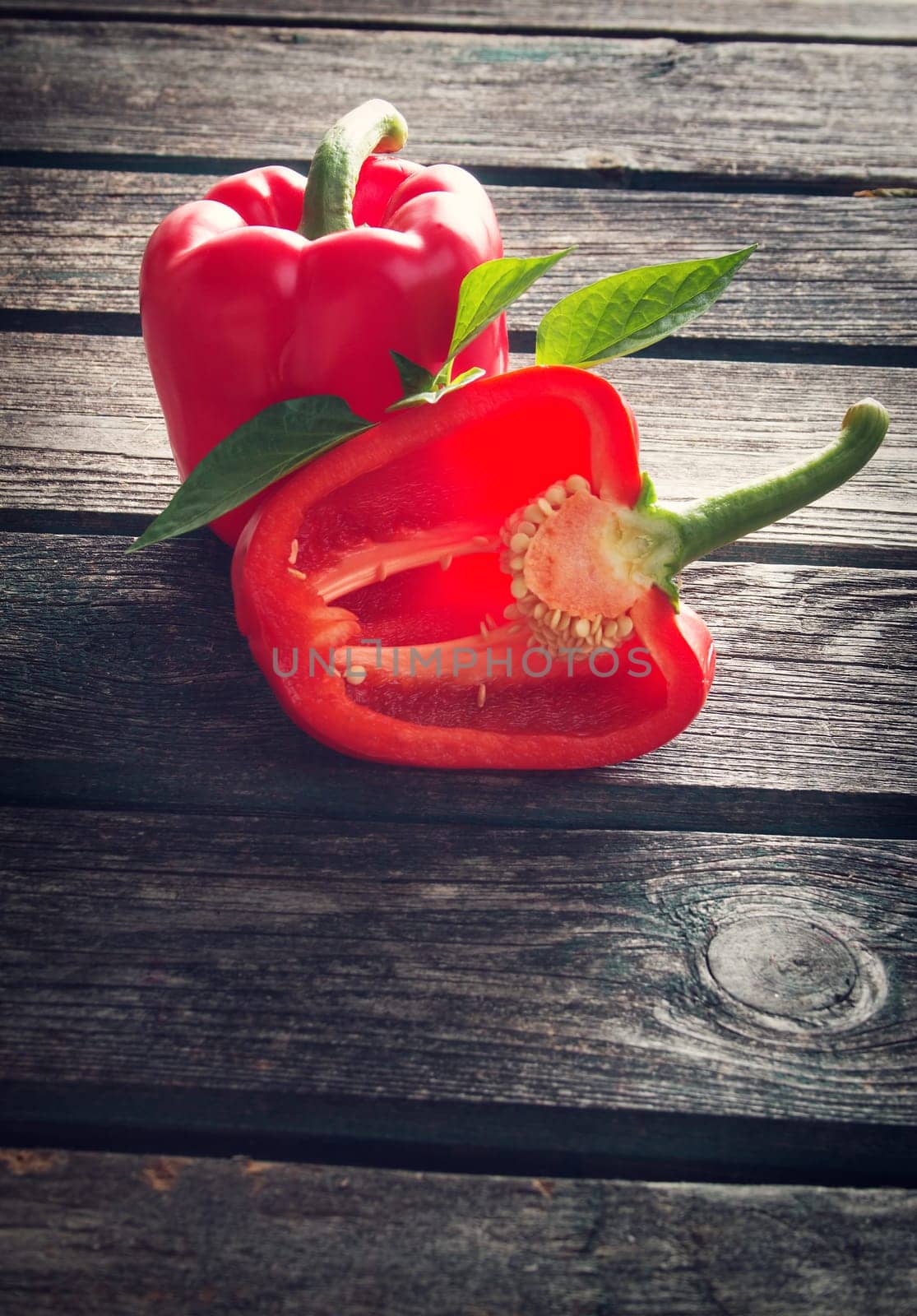 Fresh sweet red pepper on old wooden background