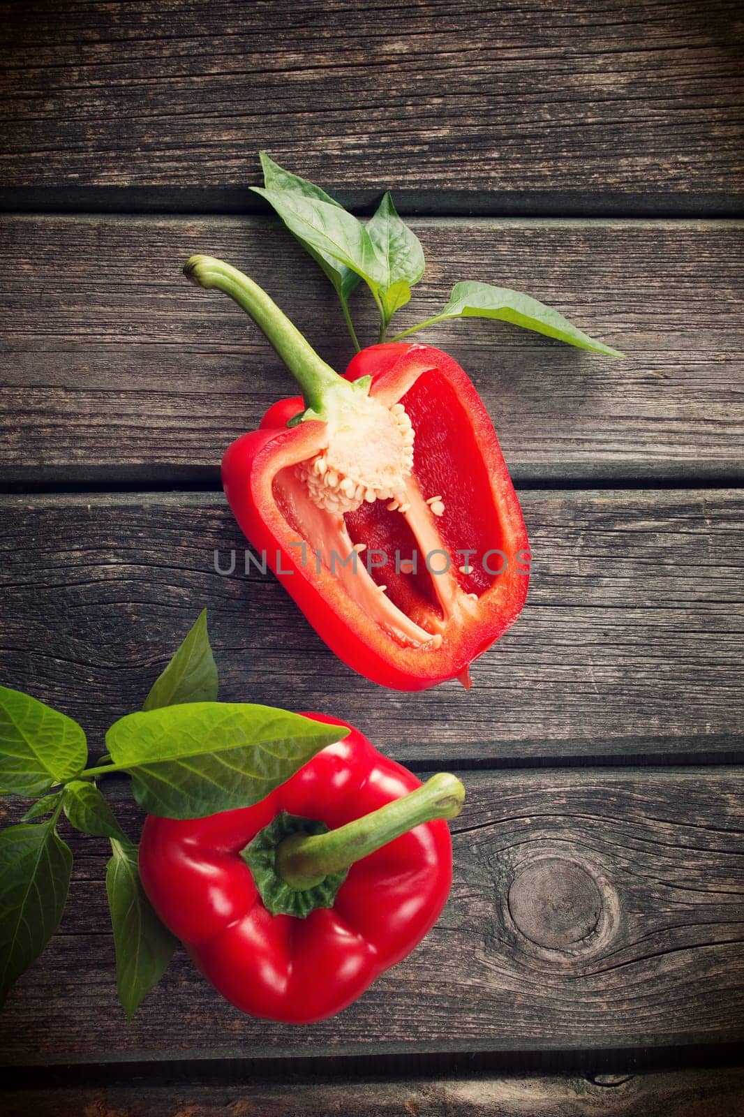 Fresh sweet red pepper on old wooden background