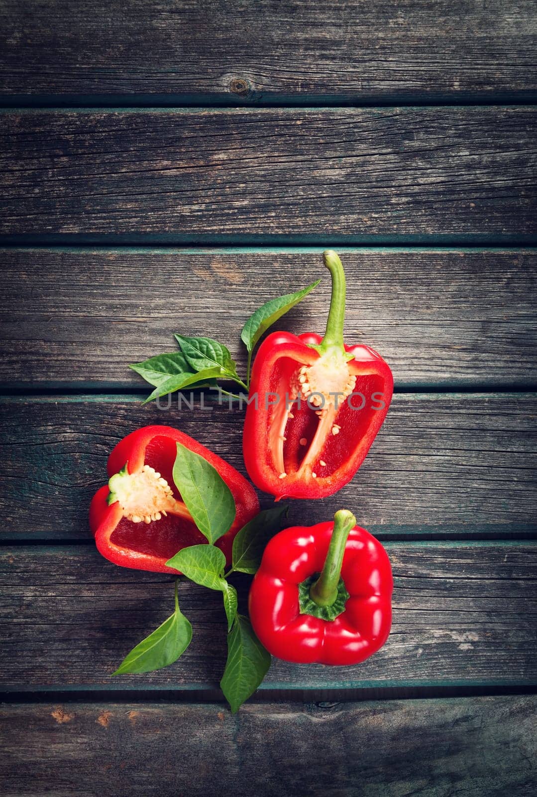 Fresh sweet red pepper on old wooden background