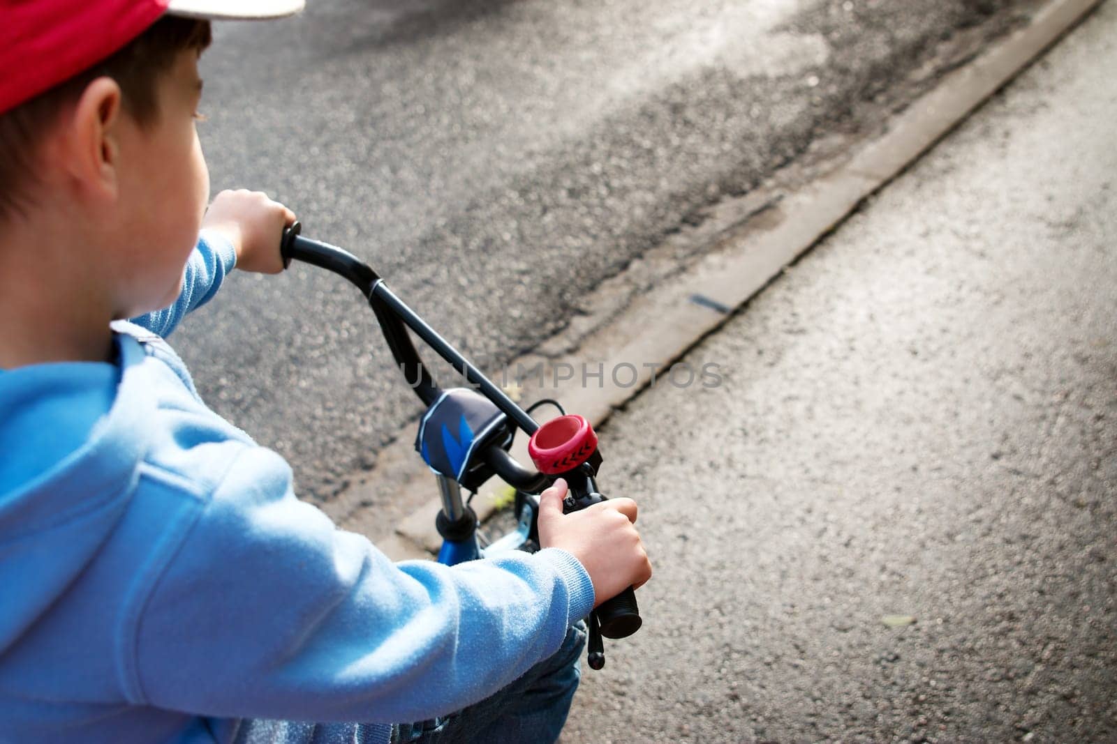 a child on a bicycle in part on asphalt road