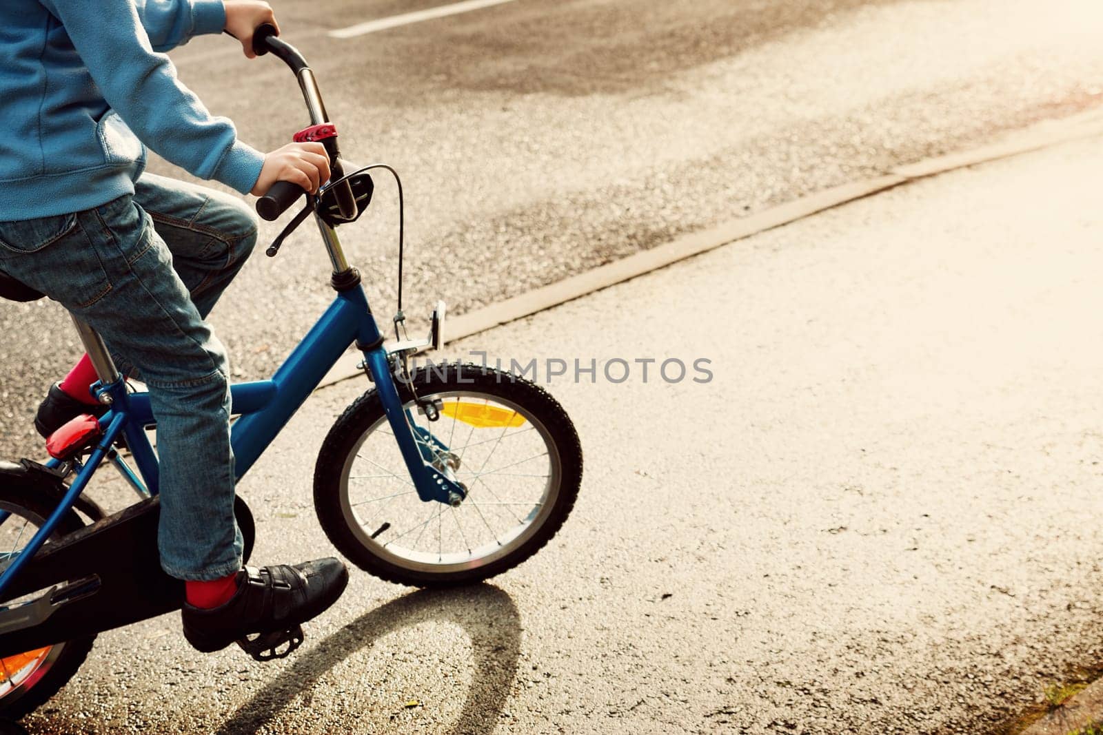 a child on a bicycle in part on asphalt road