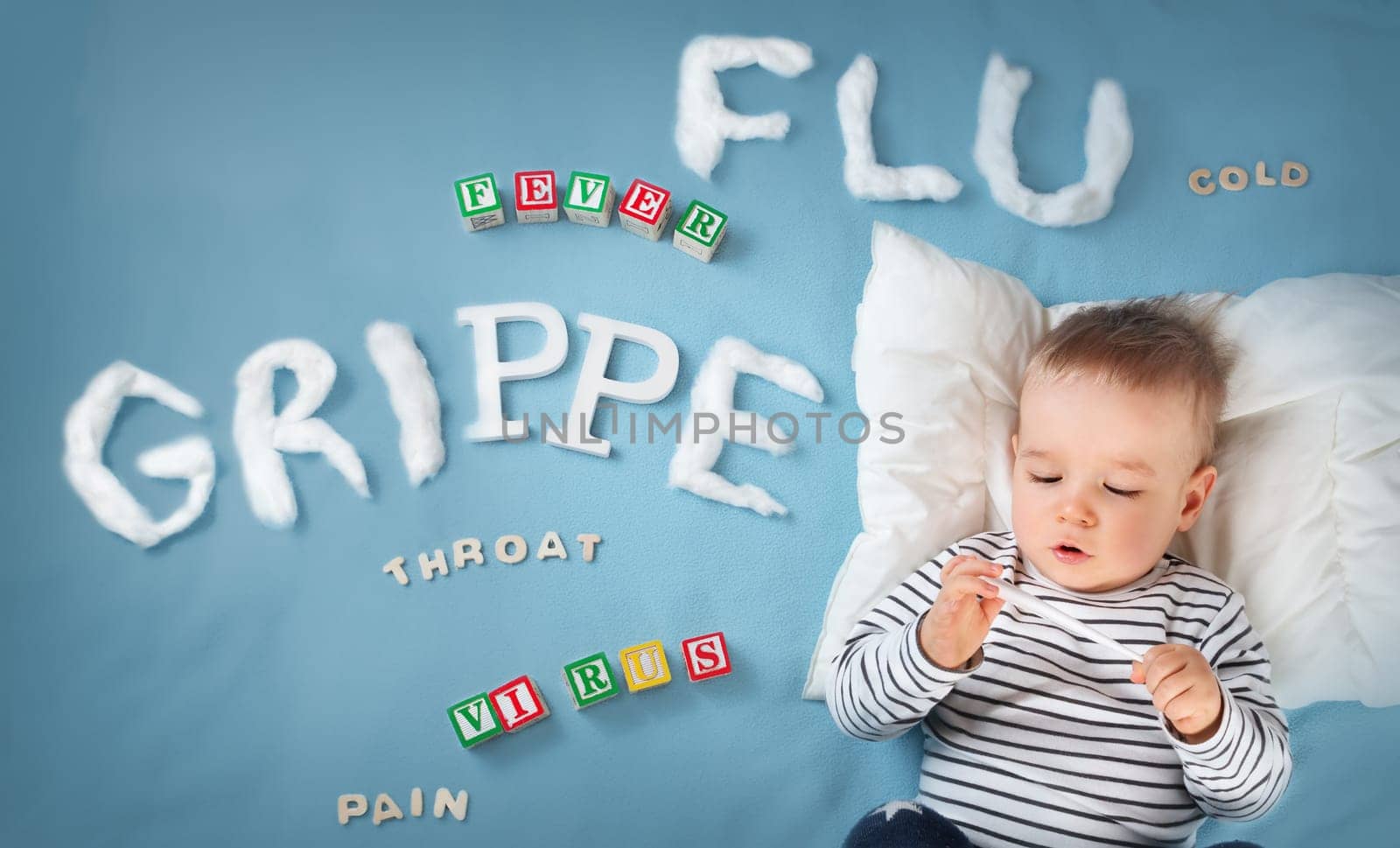 Ill boy lying in bed. baby with grippe text