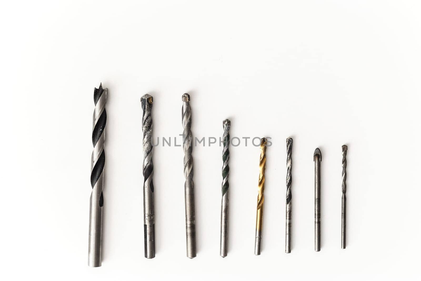 Drill bits for wood and concrete of different sizes isolated.