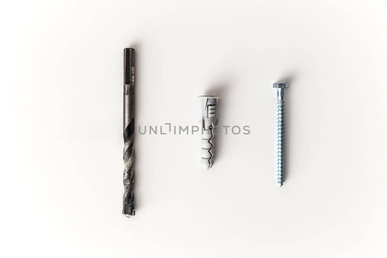 Drill bit, dowel and screw isolated on white background. Flat lay.