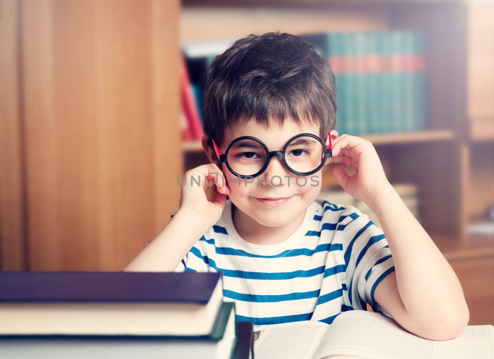 seven years old child reading a book at home