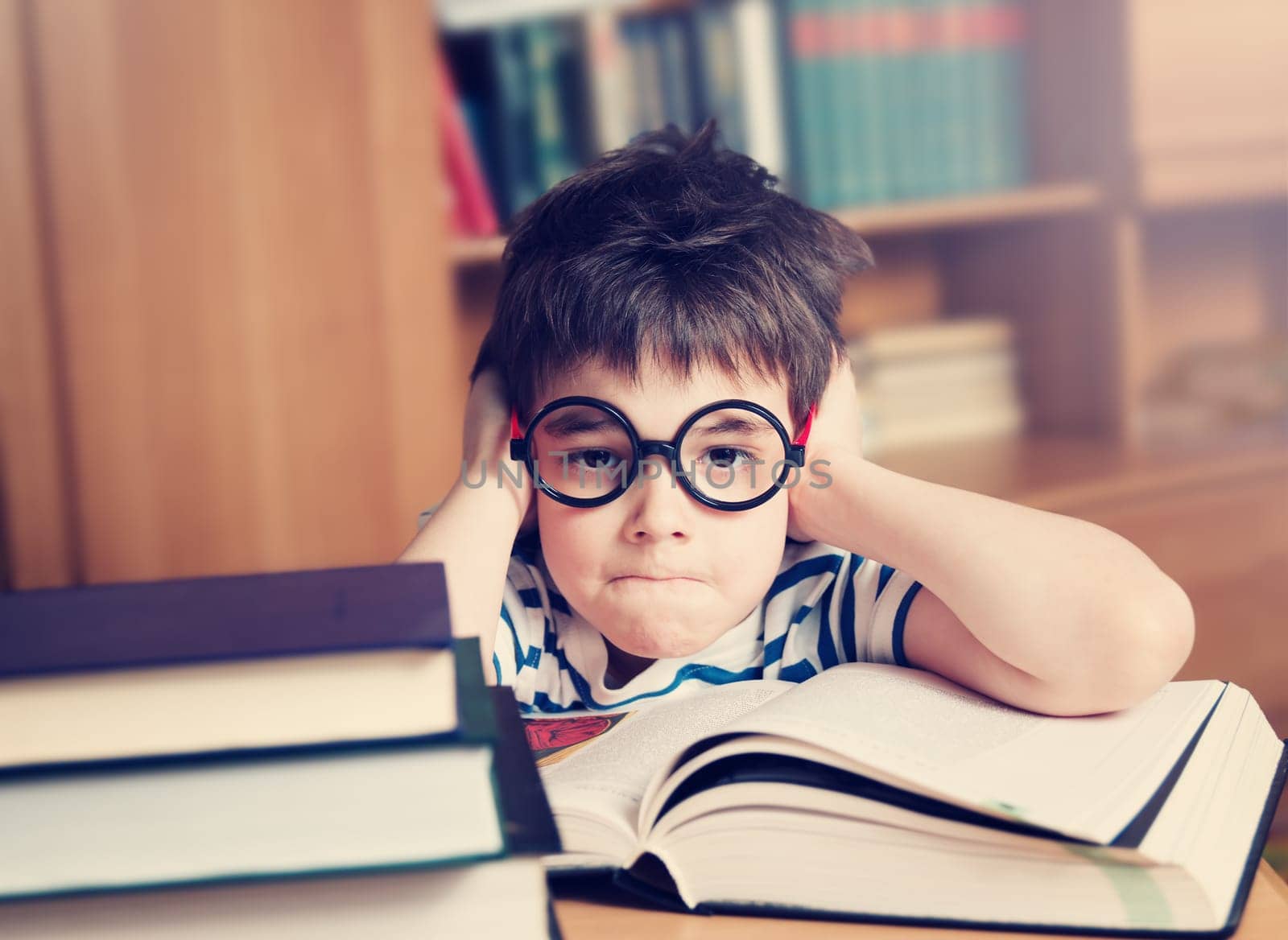 seven years old child reading a book at home