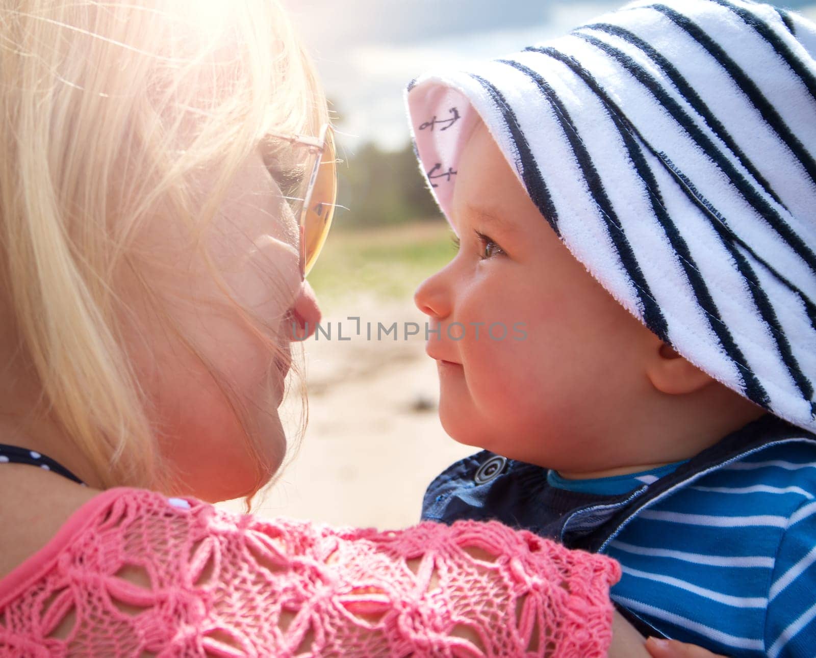 young woman and baby at the beach near sea